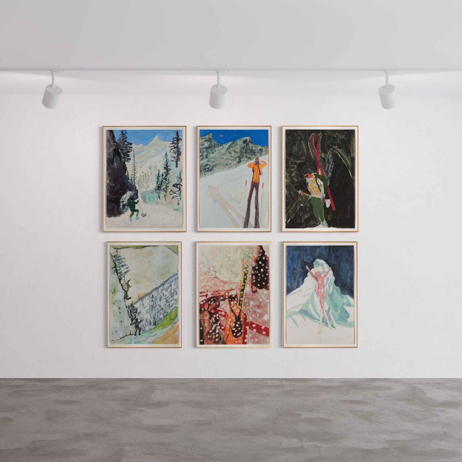 A group of paintings hanging on a wall in a room.