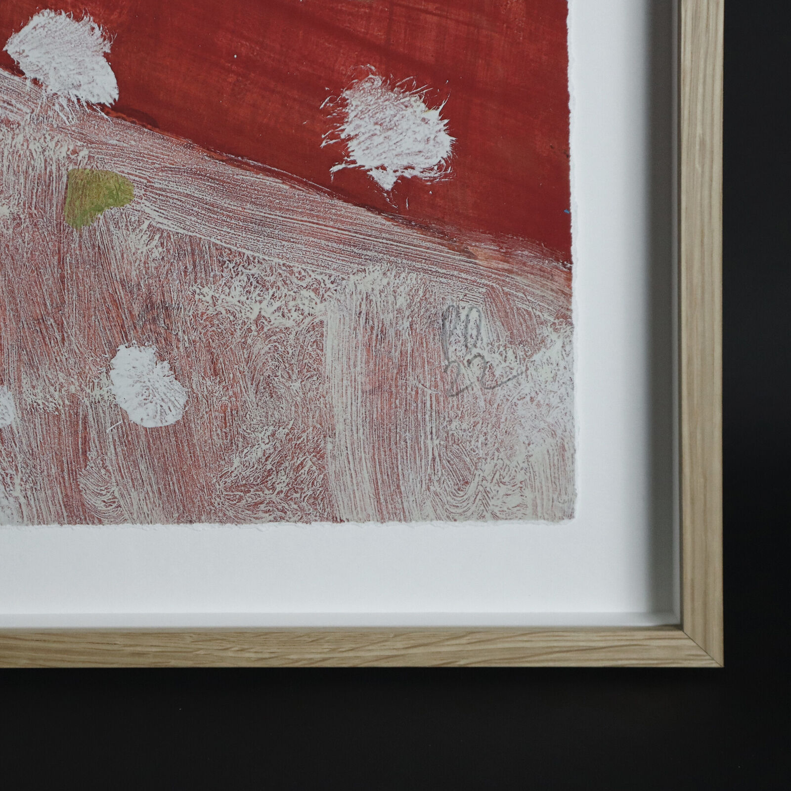 A group of paintings hanging on a wall in a room.