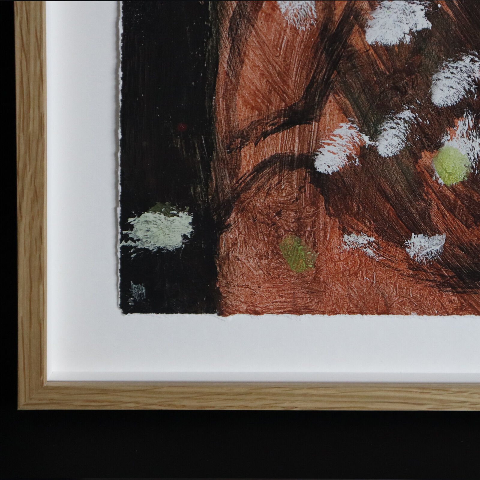 A group of paintings hanging on a wall in a room.