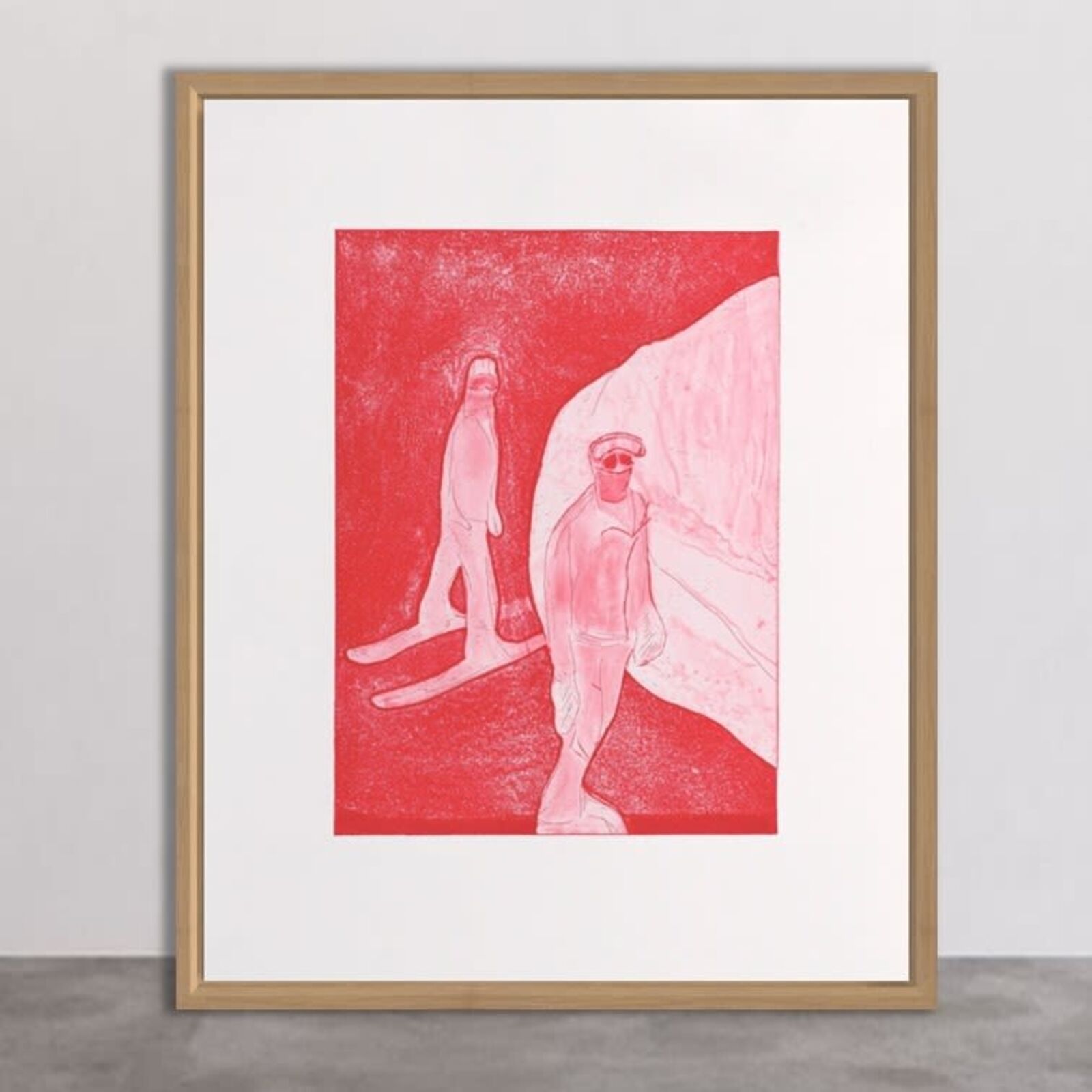 A framed print featuring two stylized figures in a red-toned landscape.