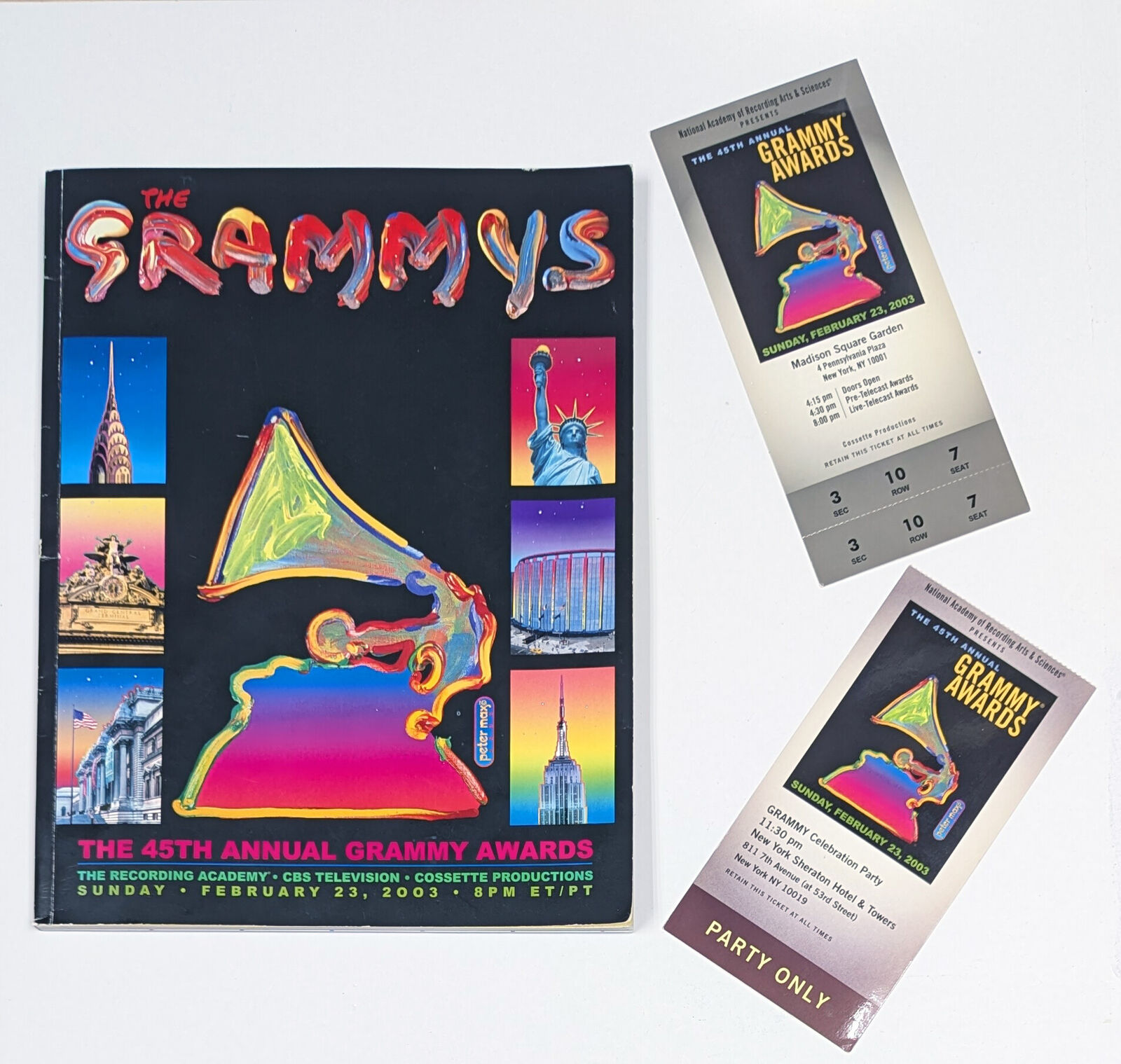 A painting of a grammy award in front of a city skyline.