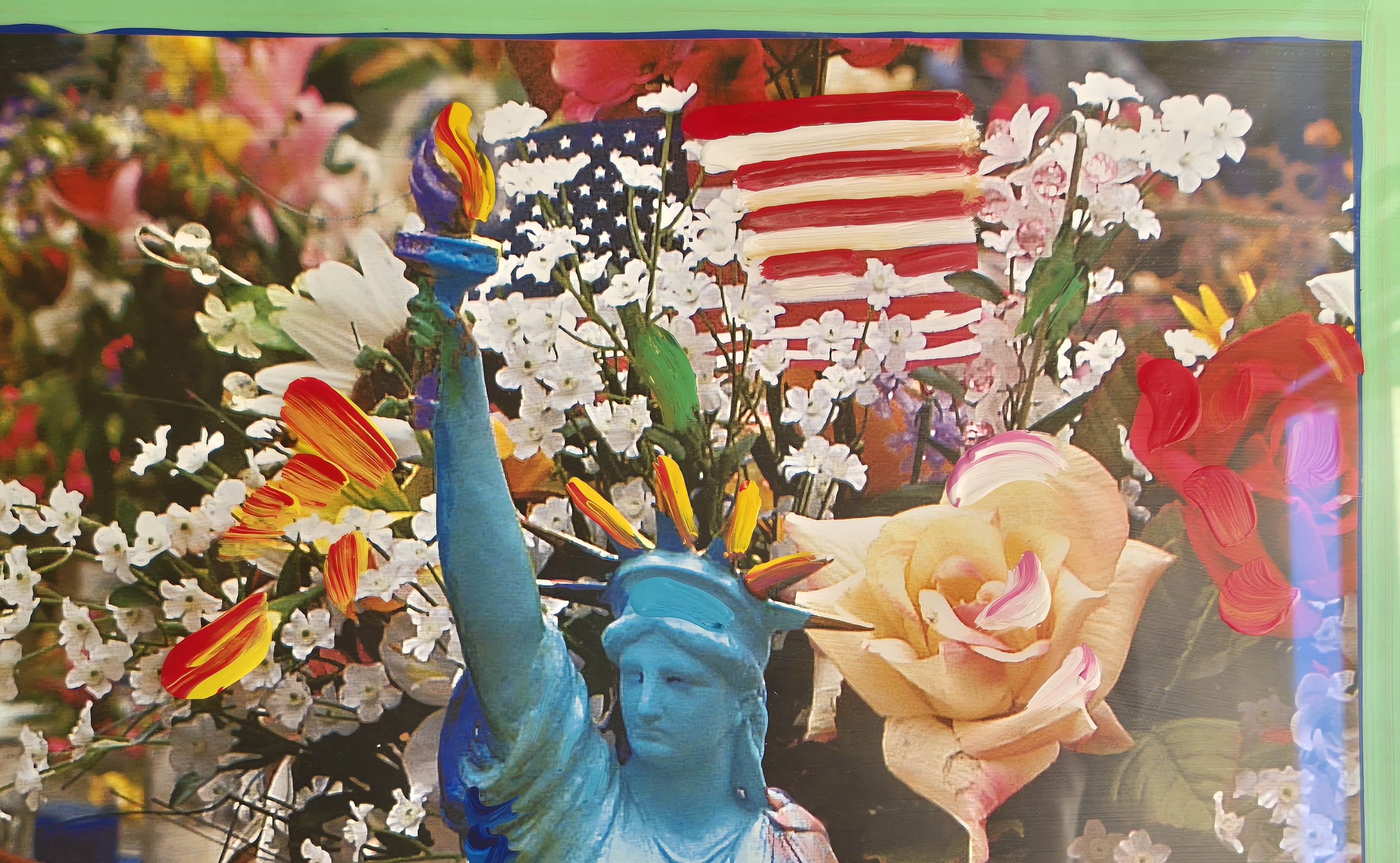 A statue of liberty surrounded by flowers and candles.