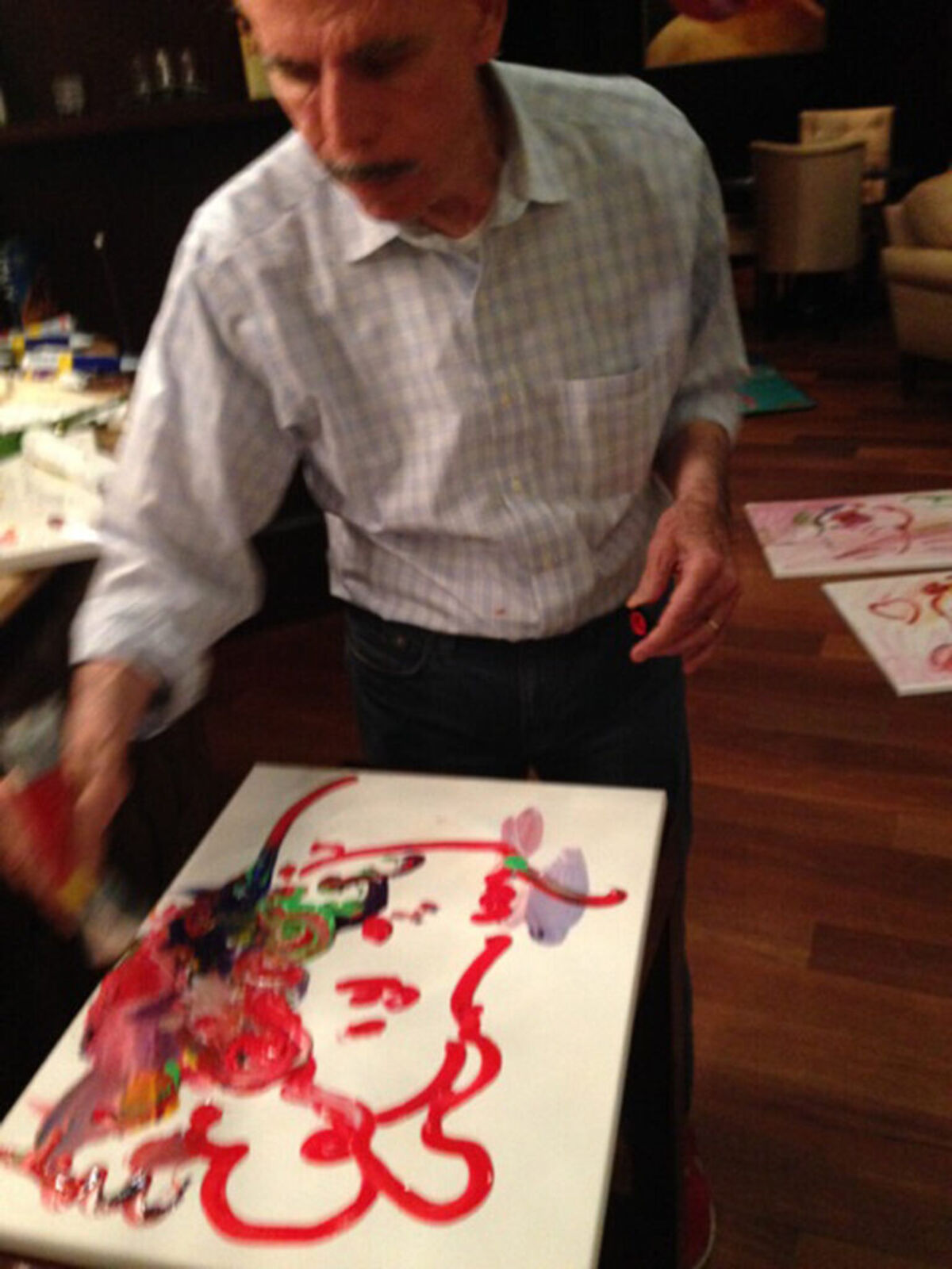 A painting of a woman's face with hearts on it.