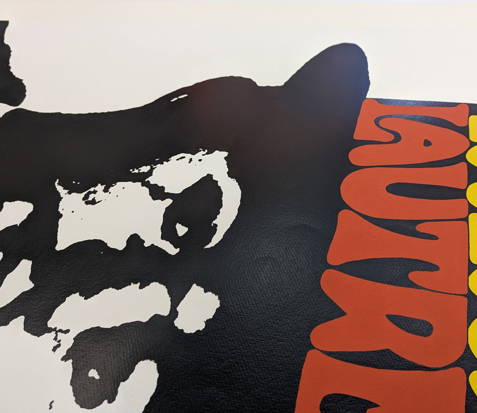 A bold graphic portrait of a bearded figure in silhouette wearing a bowler hat with colorful text.
