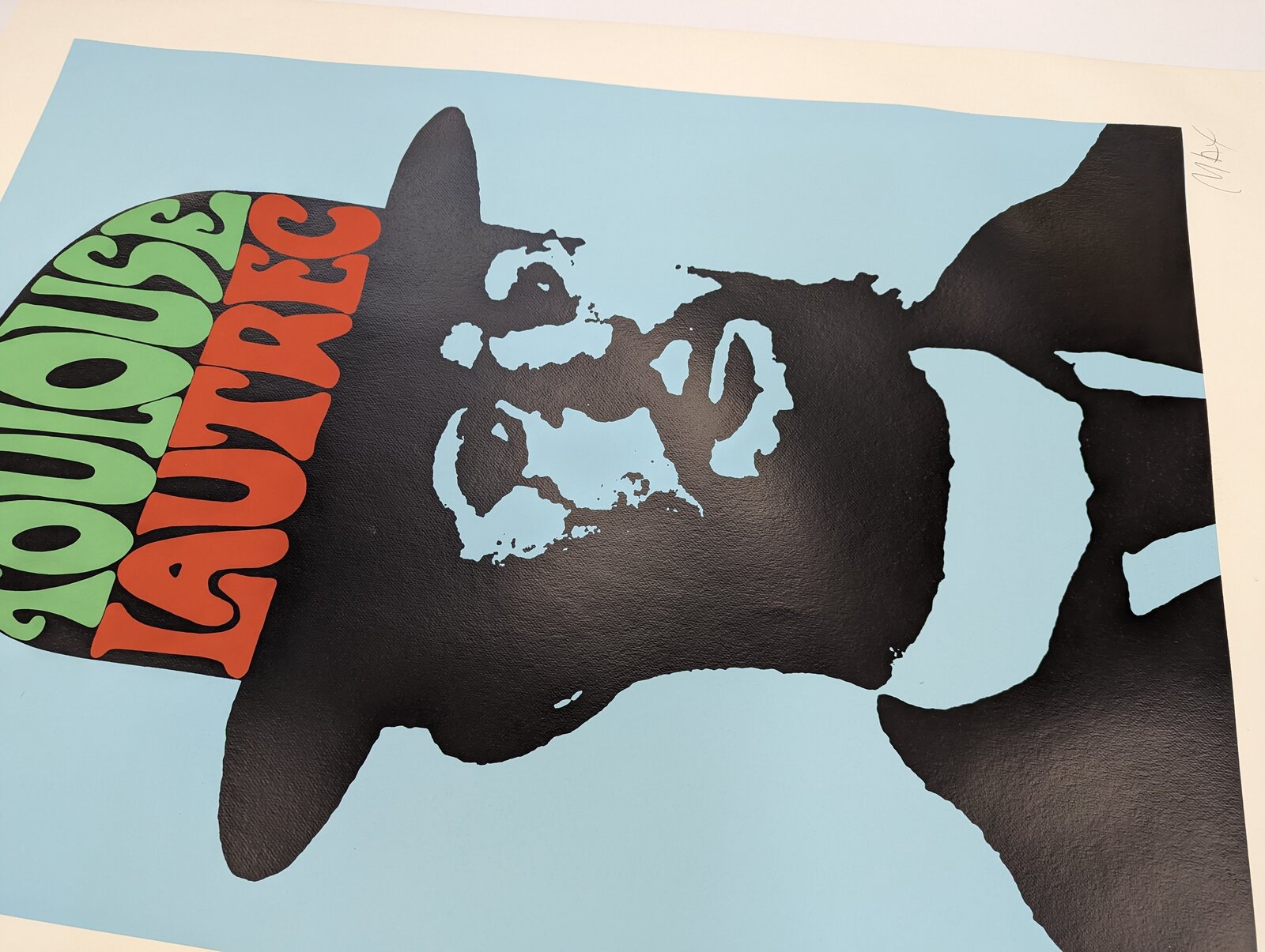 A bold graphic portrait of a bearded figure in silhouette against a light blue background, wearing a hat filled with colorful text.