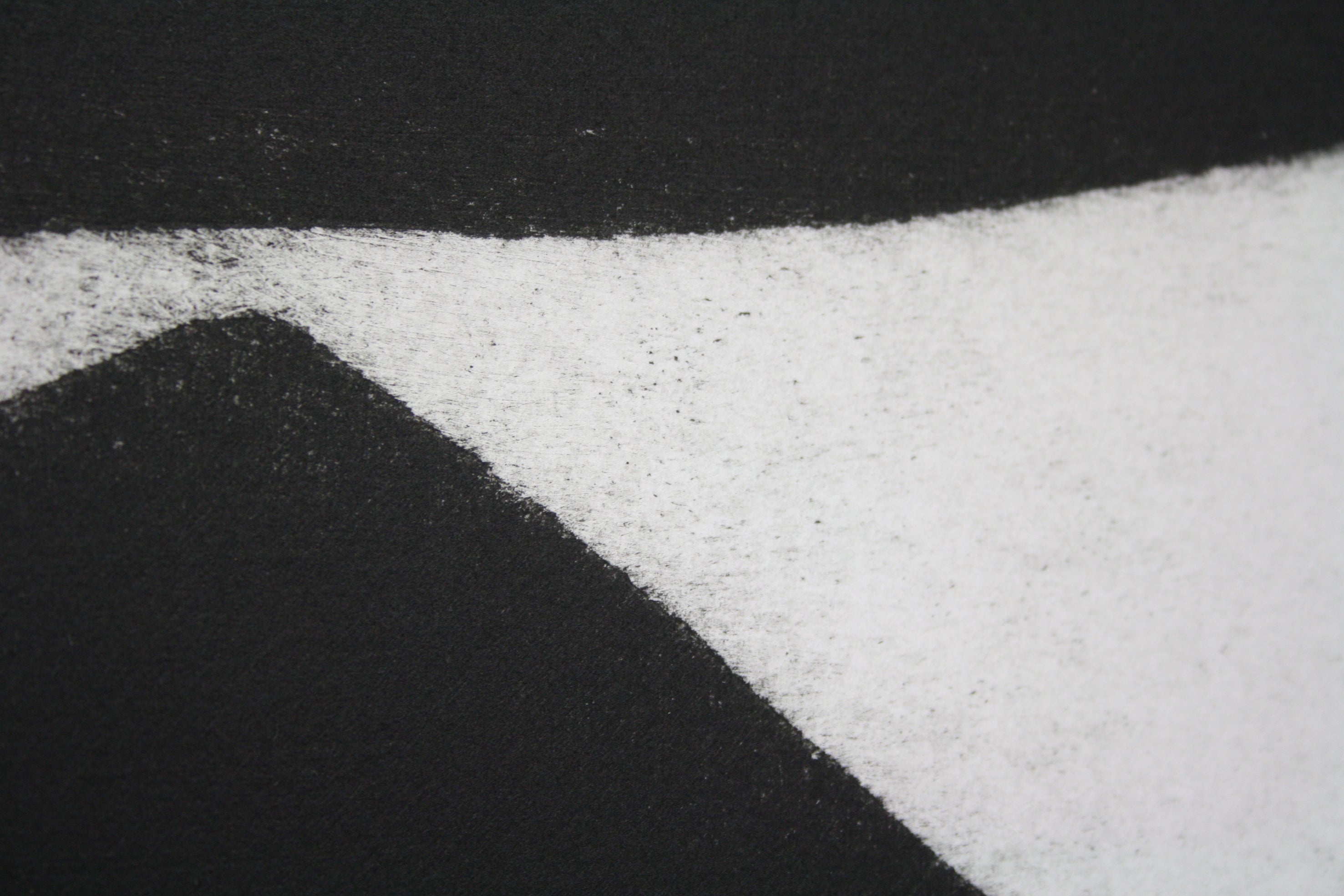 A black and white painting on a white wall.