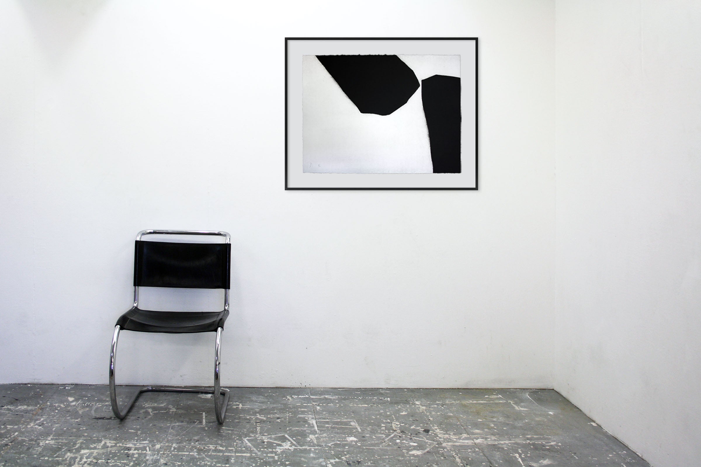 A black and white painting on a white wall.