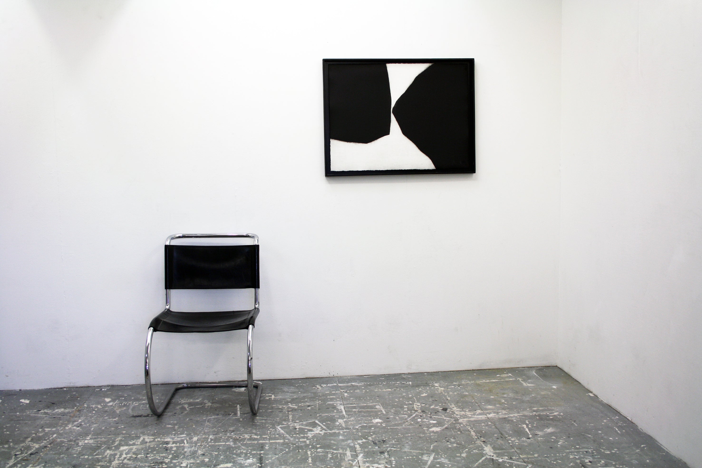 A black and white painting on a white wall.