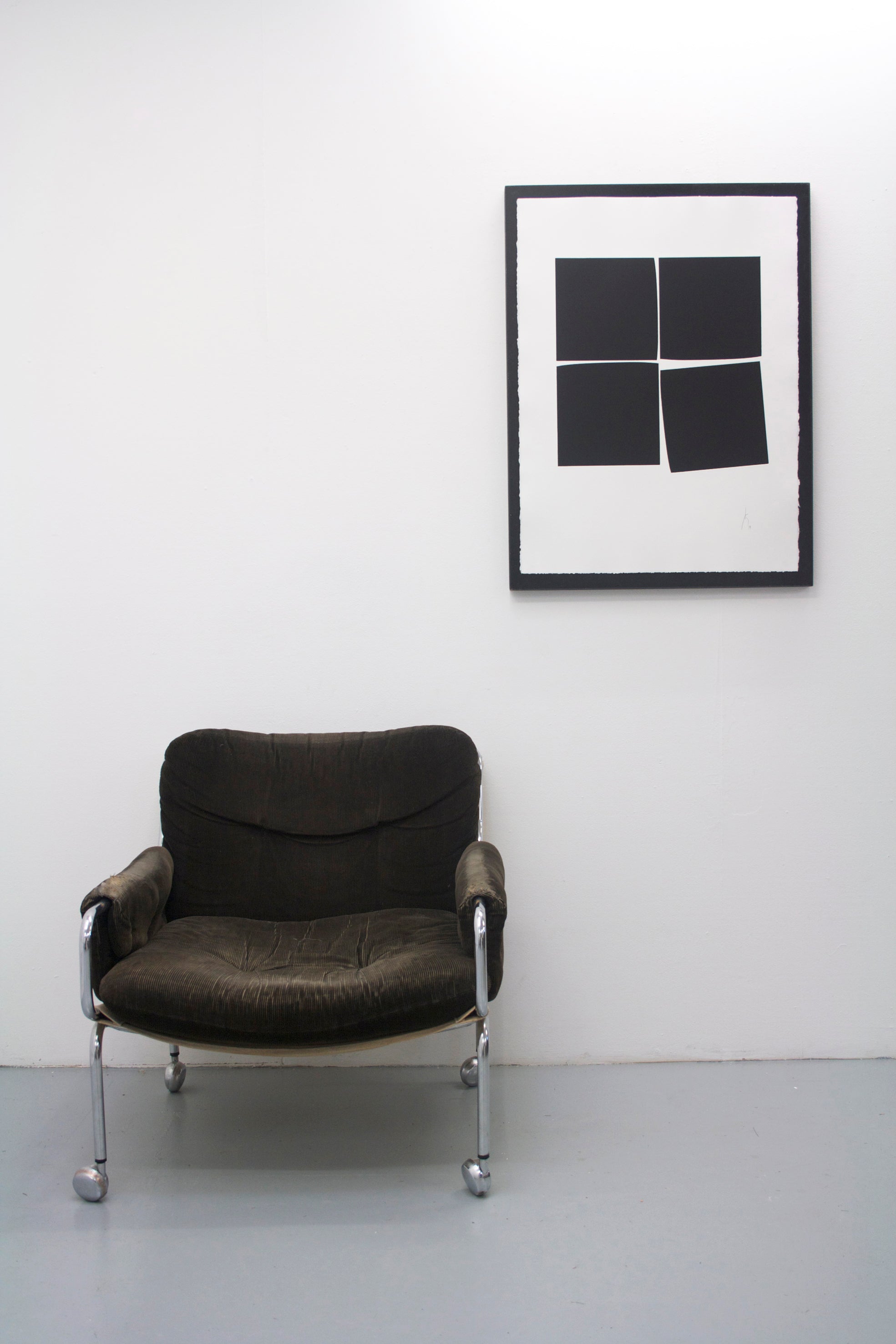 A black and white photo of four squares on a white background.