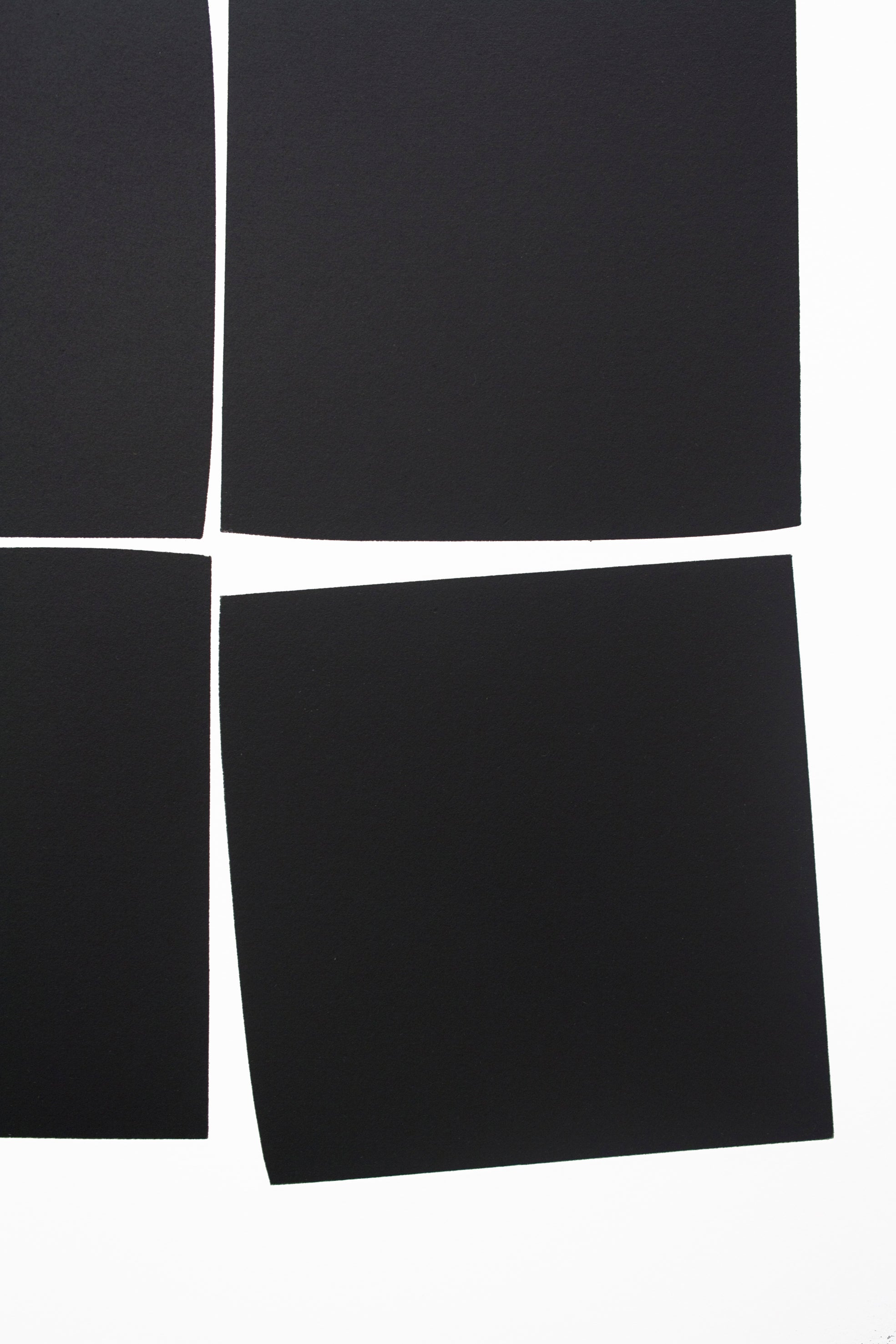 A black and white photo of four squares on a white background.
