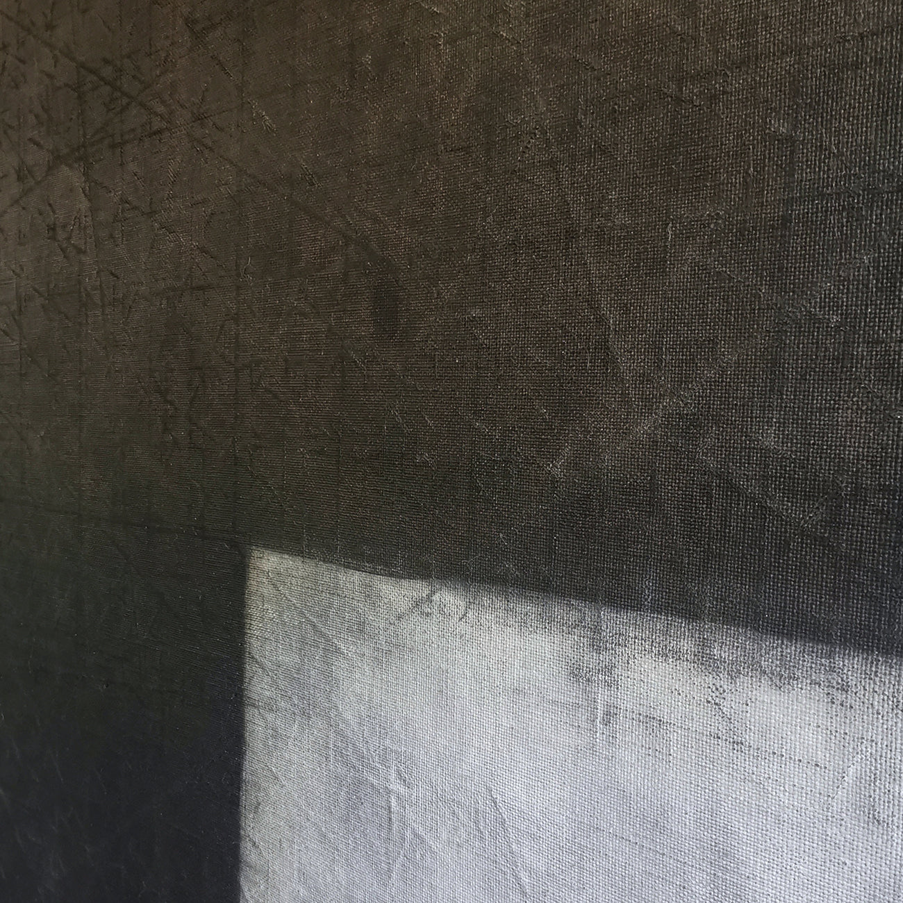 A black and white painting of a cross on a gray background.