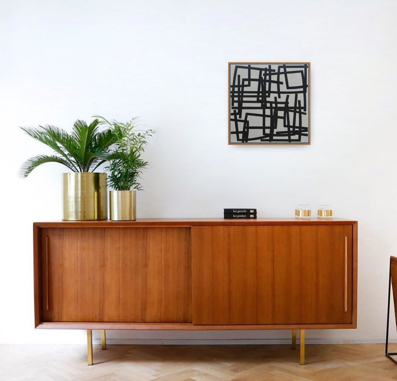 A black and white painting on a white wall.