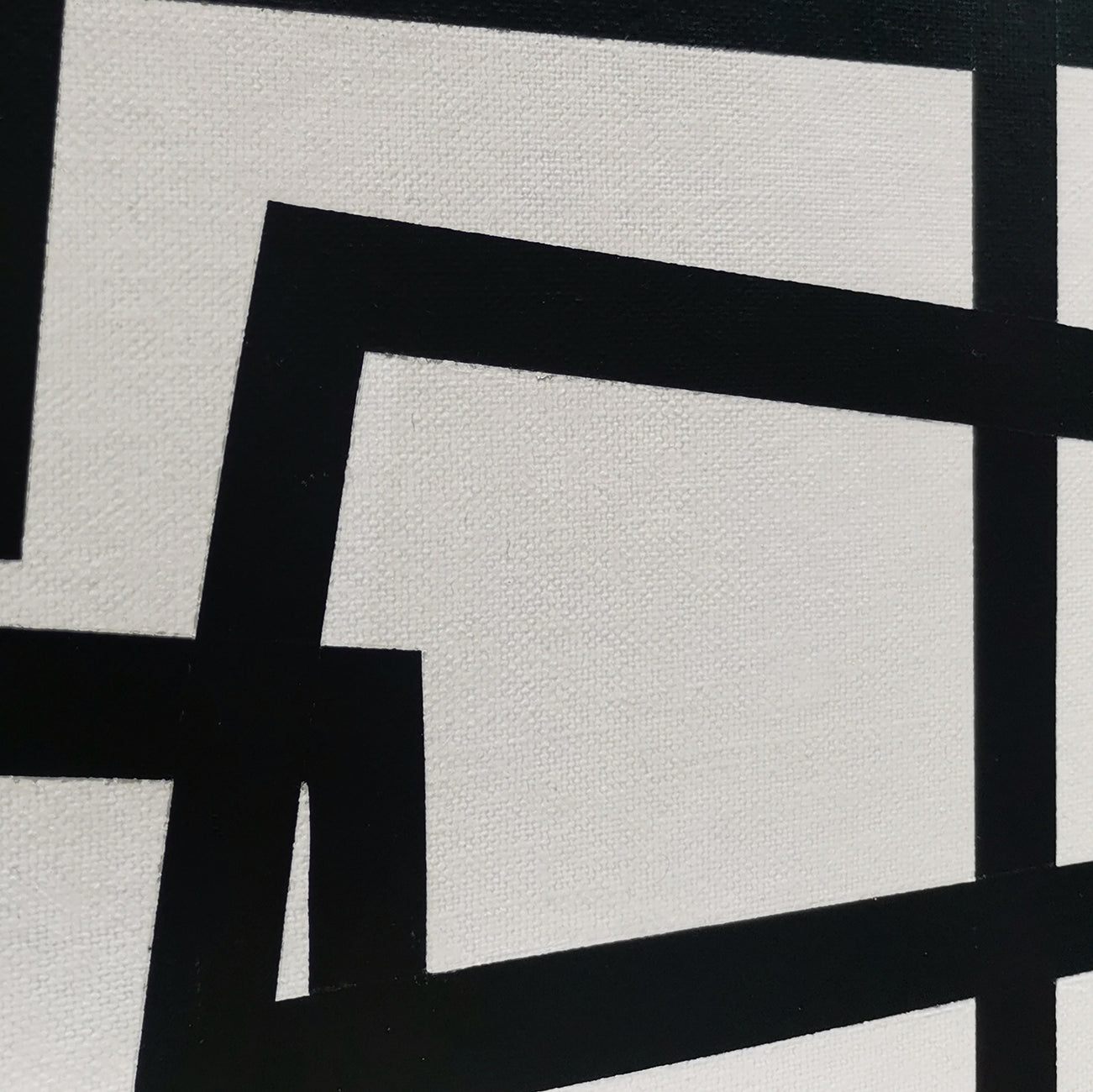 A black and white painting on a white wall.