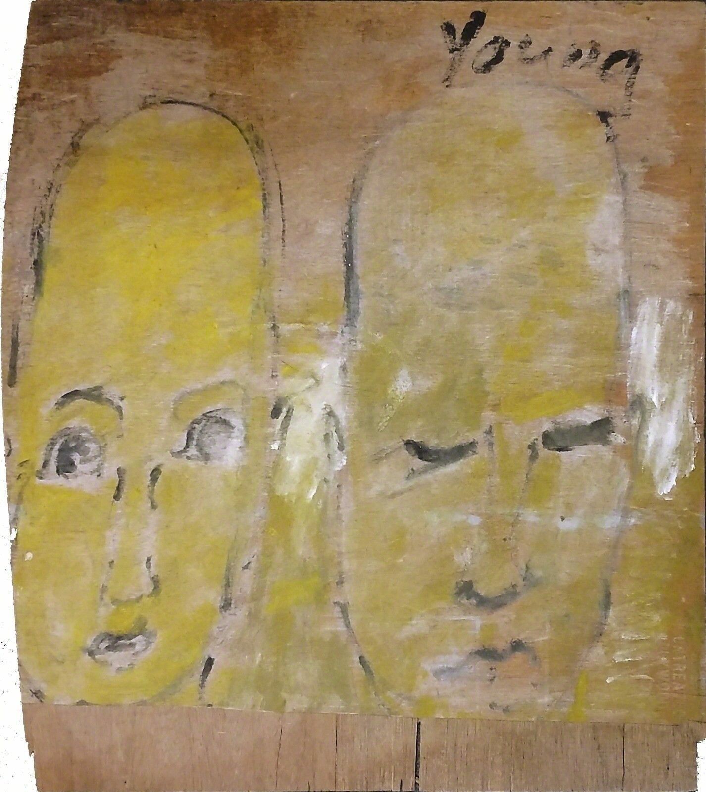 A painting of two faces on a piece of wood.
