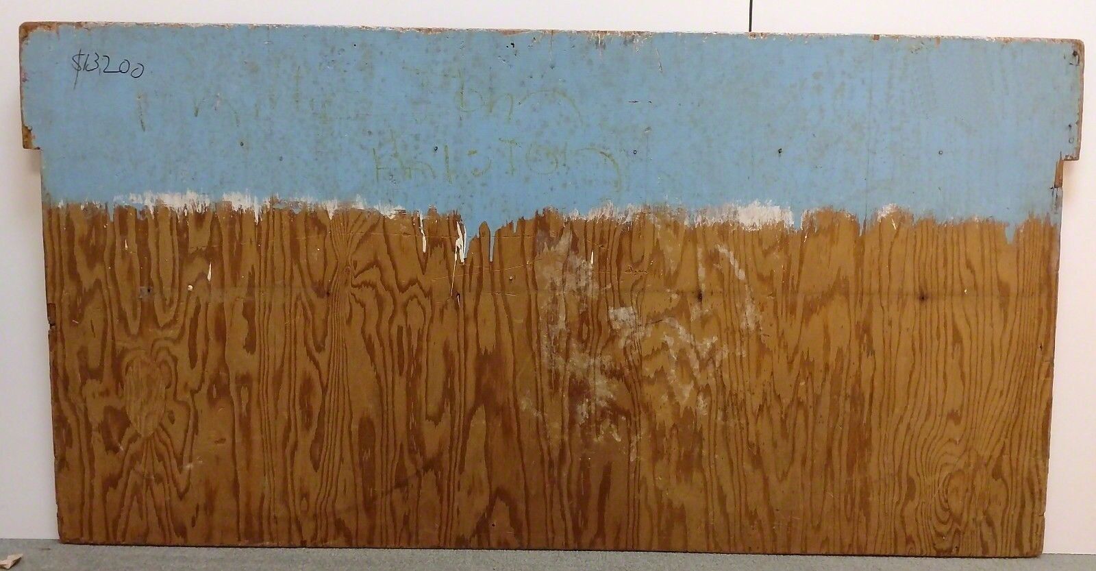 A painting of a group of people on a wooden surface.