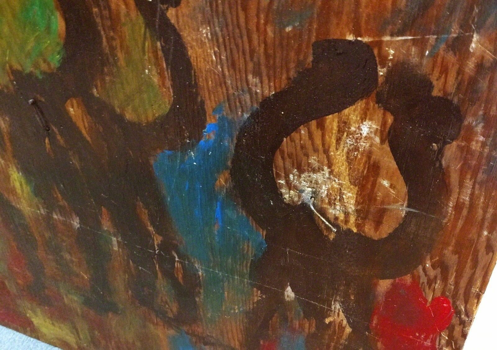 A painting of a group of people on a wooden surface.