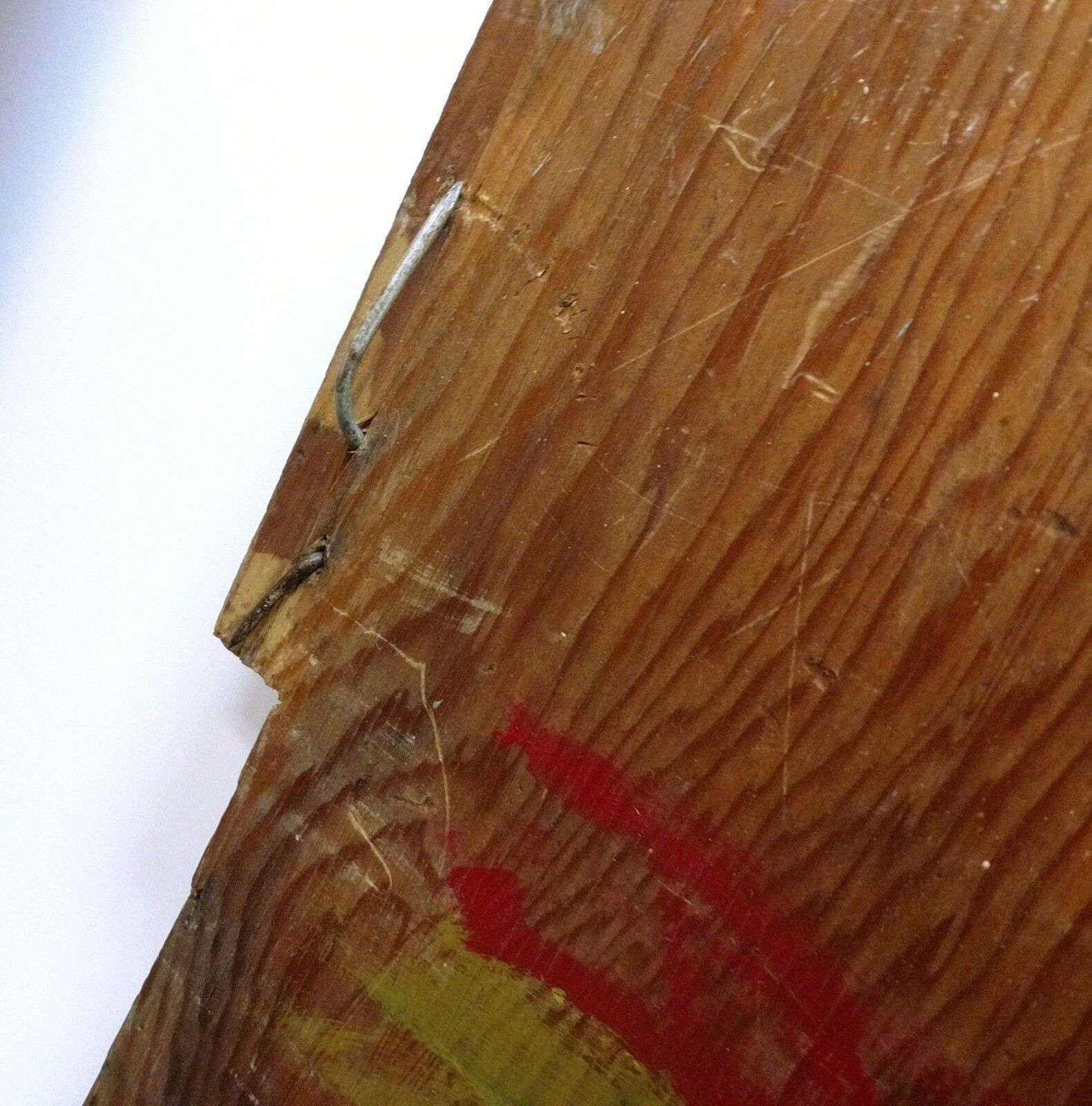 A painting of a group of people on a wooden surface.