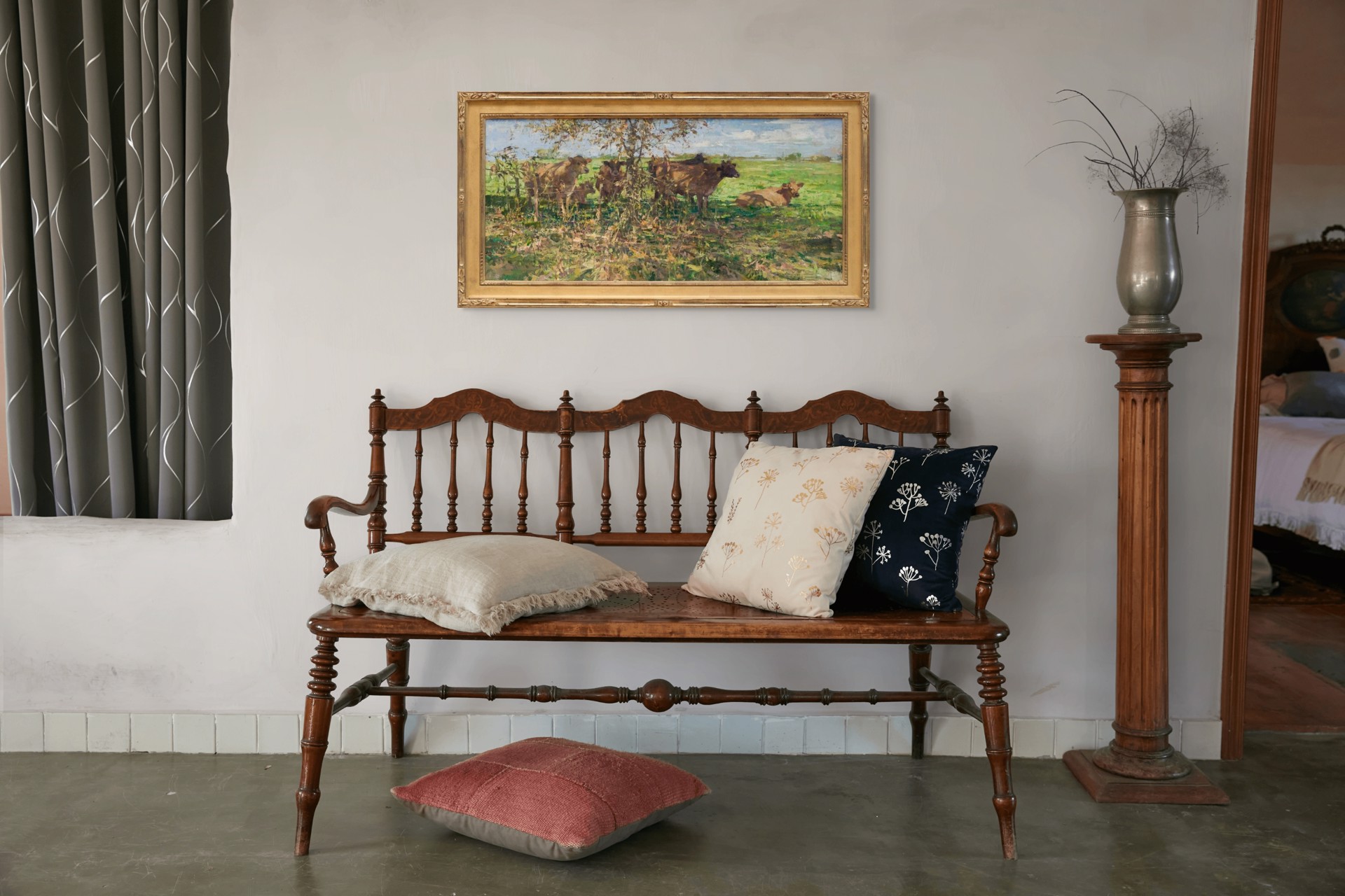 A painting of cows in a grassy field under a tree.