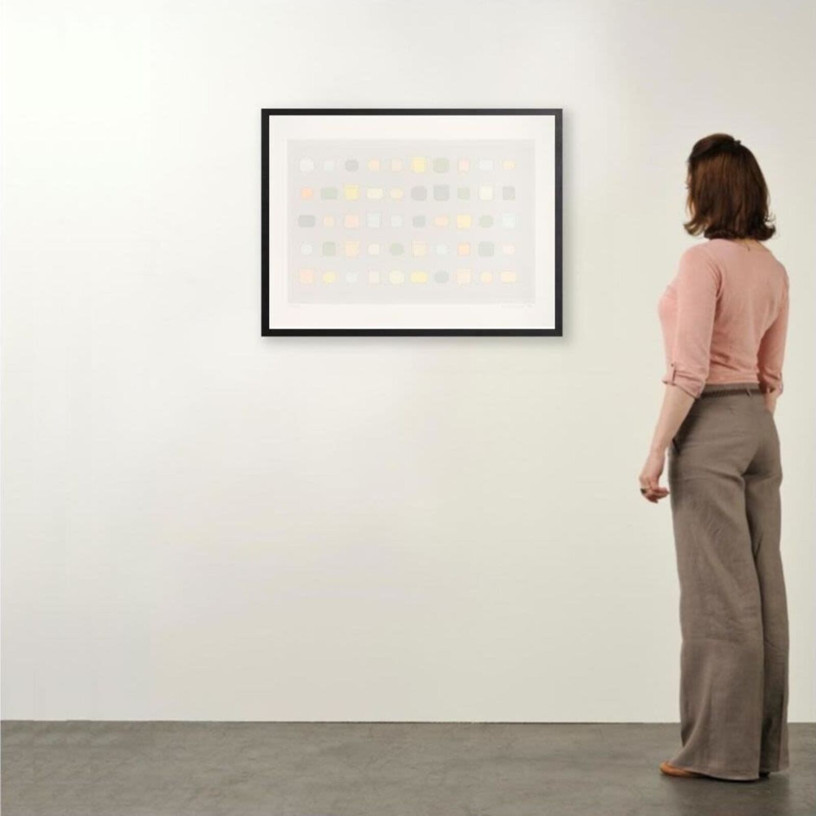 A framed print of a white wall with a black frame.