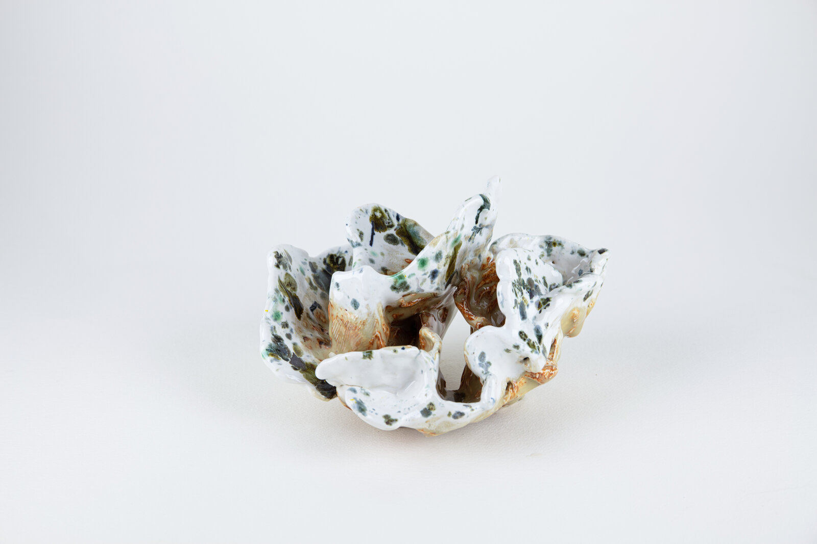 A white and green bowl sitting on top of a table.