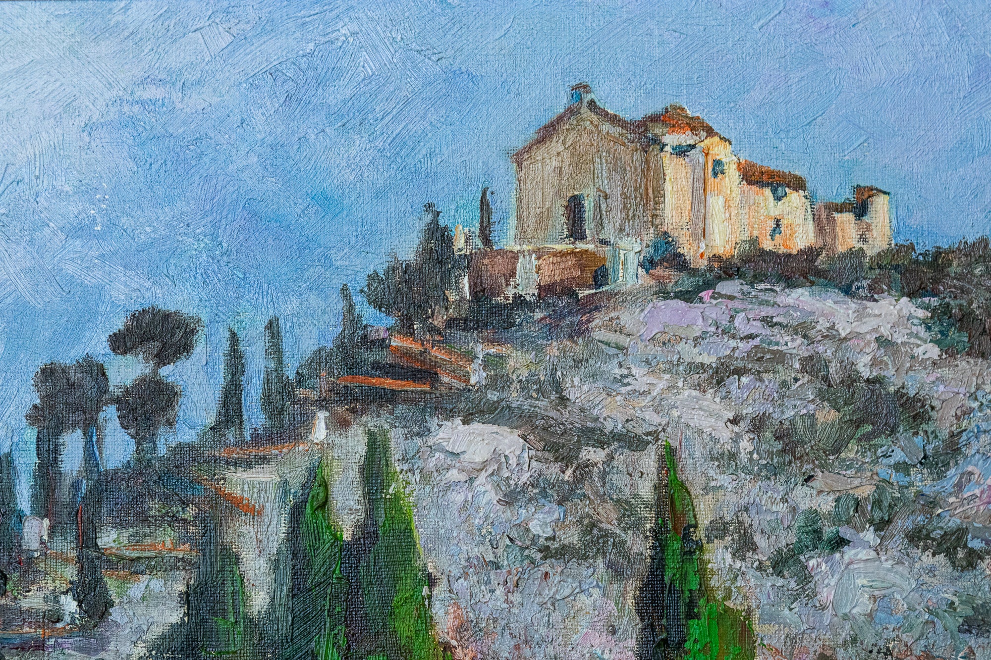 A painting of a landscape with a church on a hill.