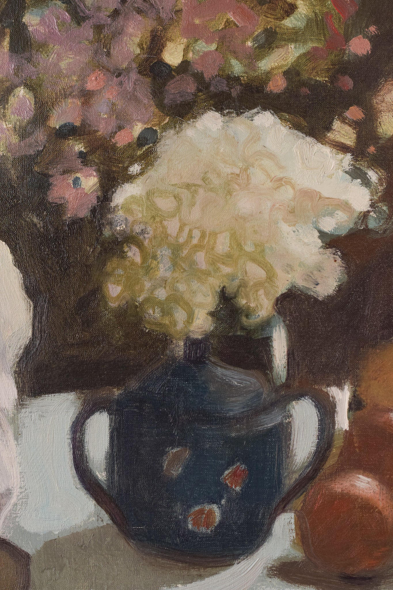 A painting of a woman sitting at a table with a book and a vase of flowers.