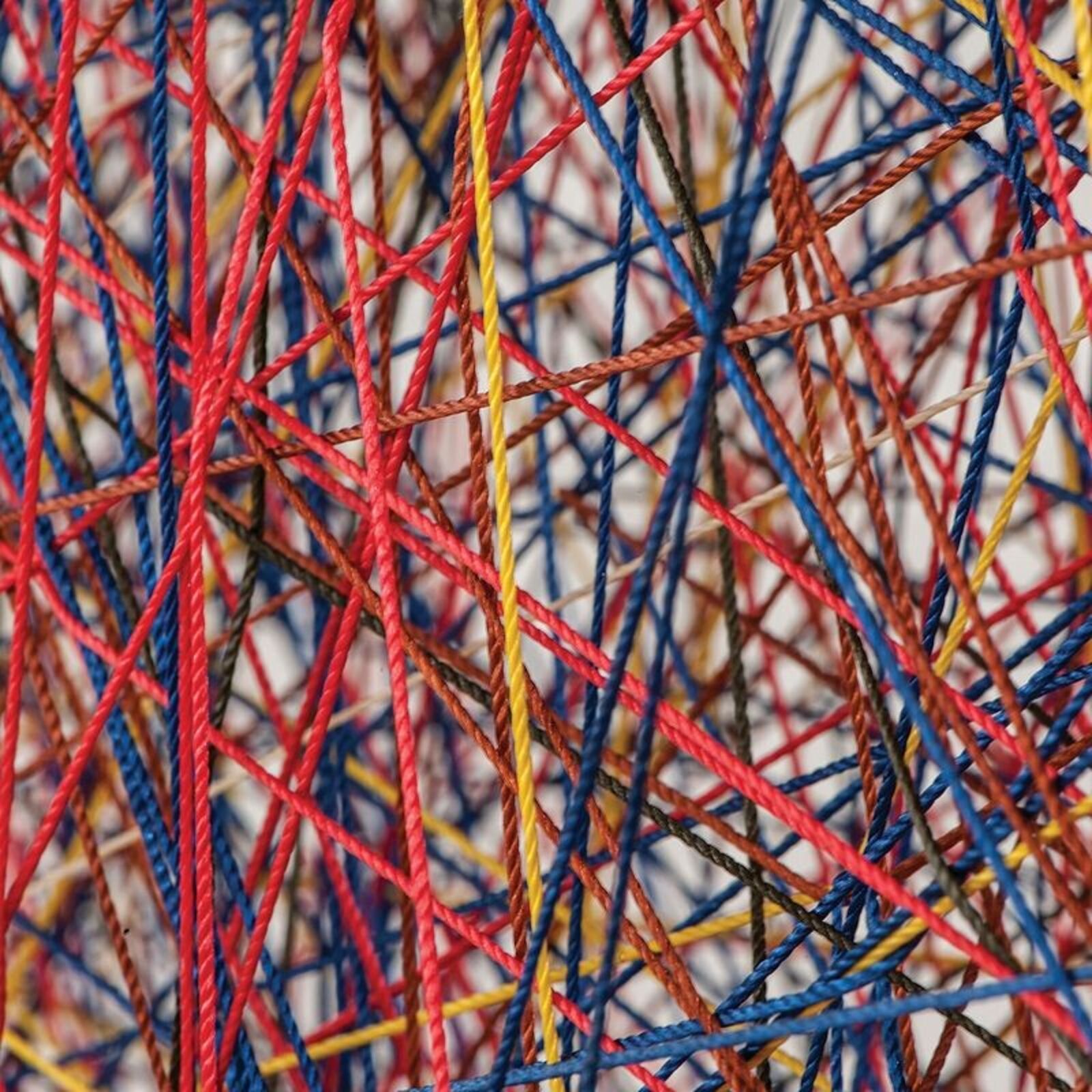 A large metal sculpture on a wooden floor in a room.