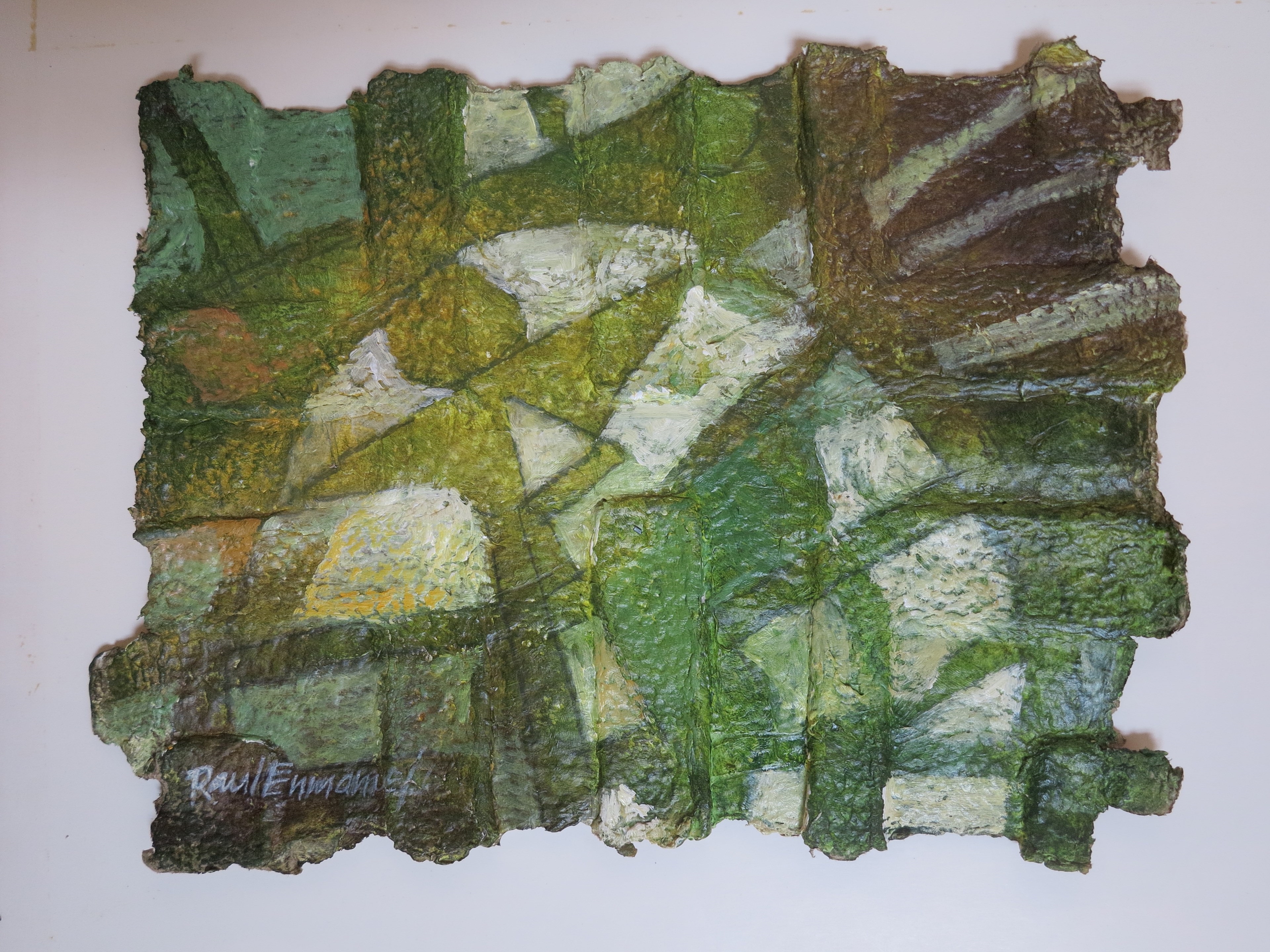 A piece of green and white art on a white wall.
