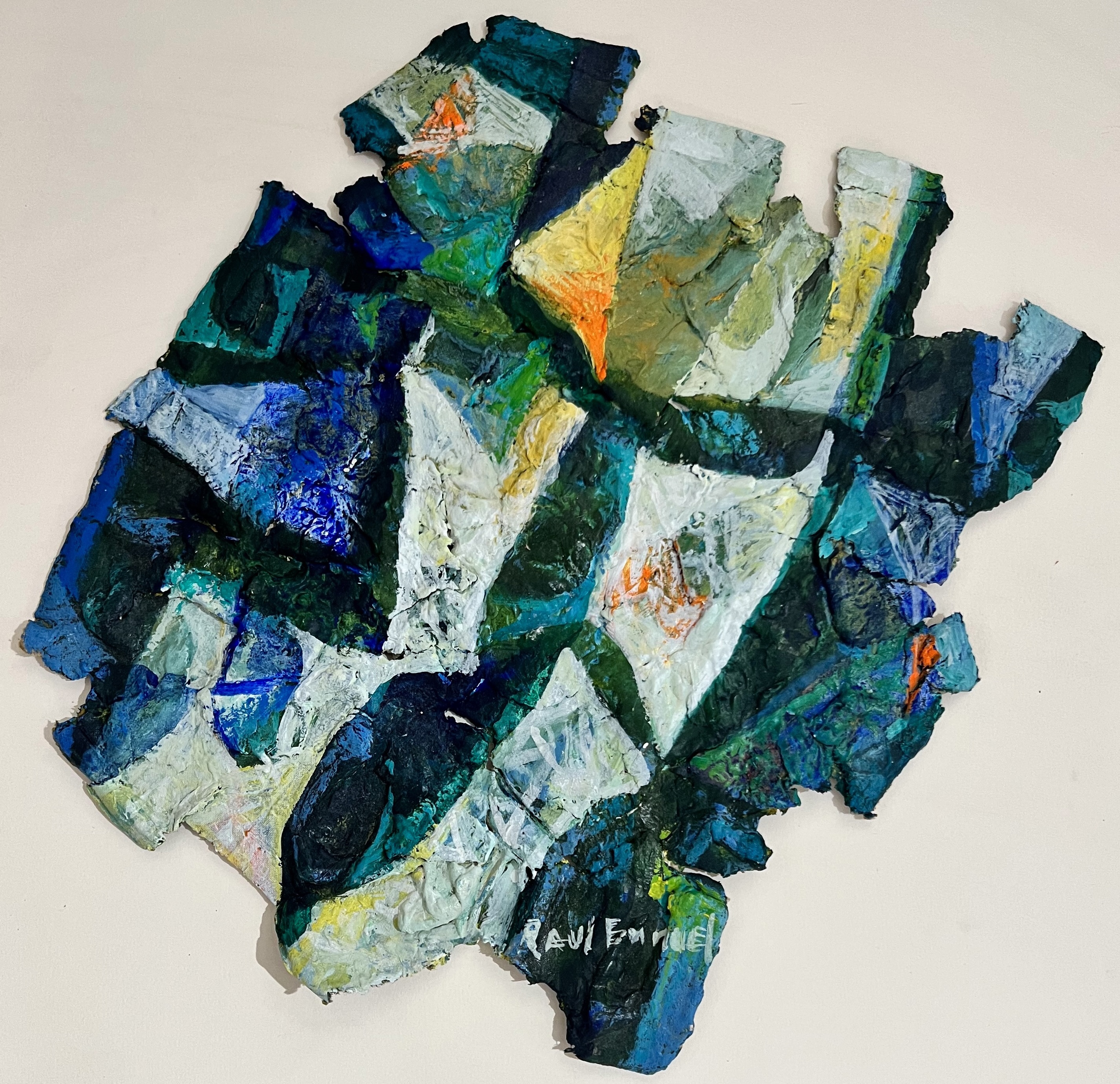 A piece of art that is on a white surface.