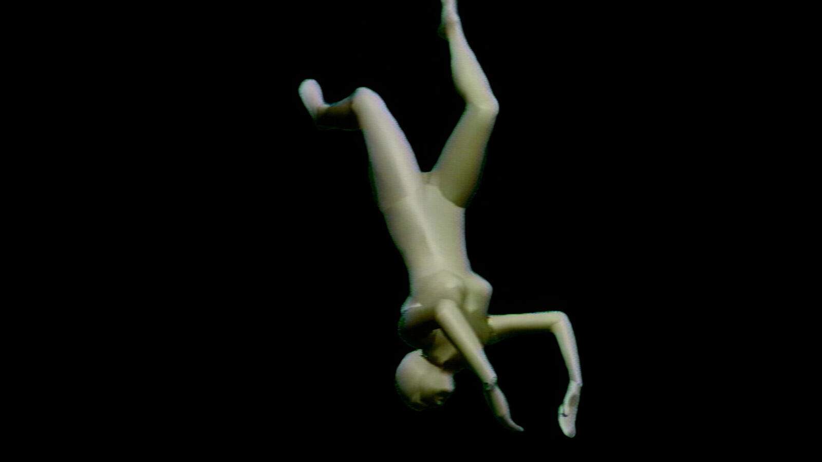 A mannequin is upside down in the air. 