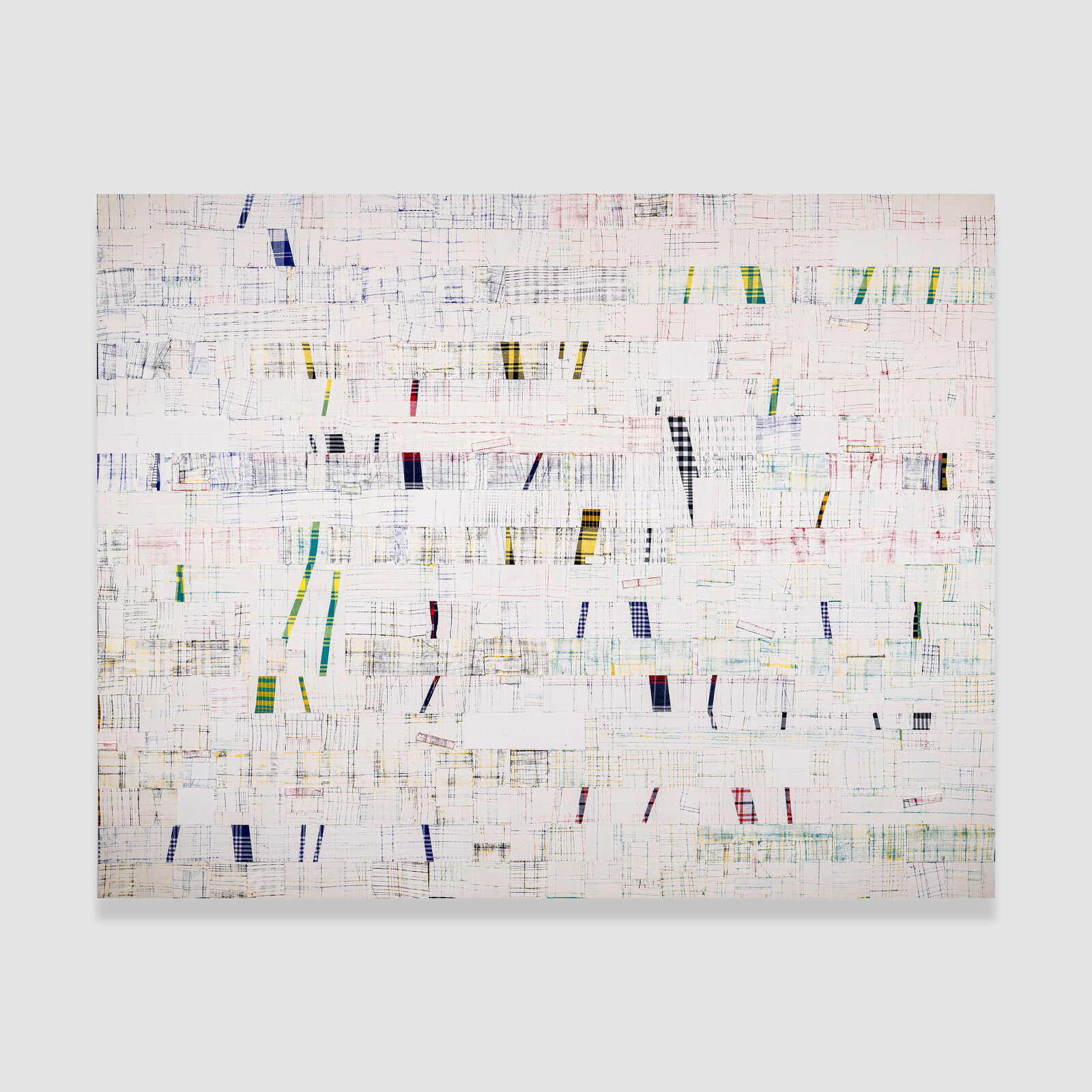 A piece of art that is on a white wall.