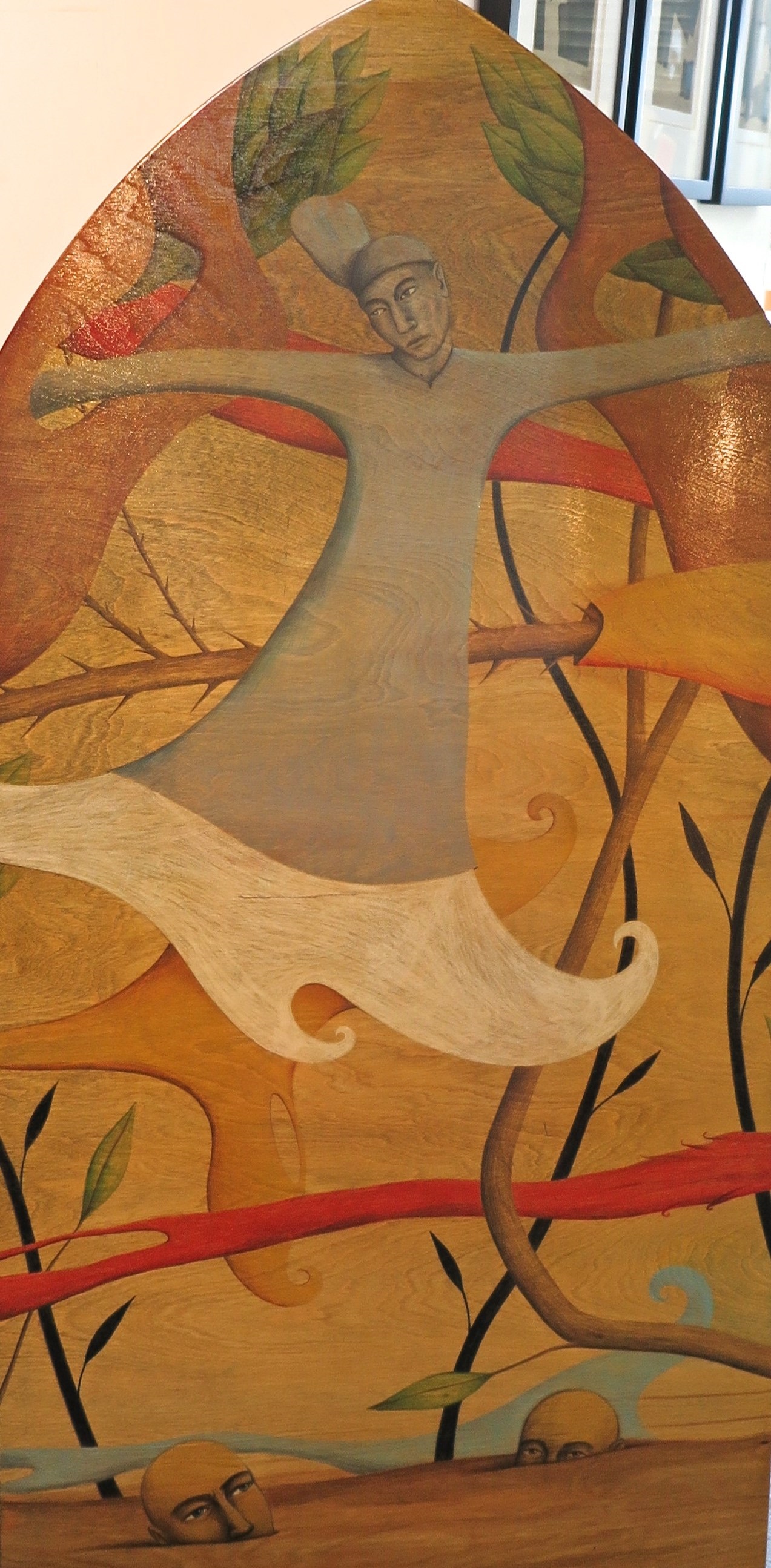 A painting of a woman in a white dress on a wall.
