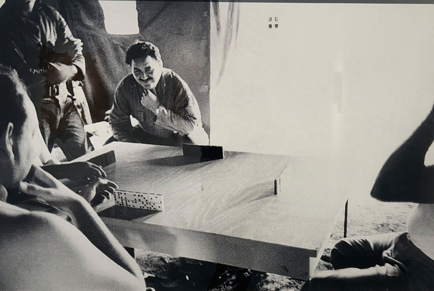 A group of people sitting around a wooden table.
