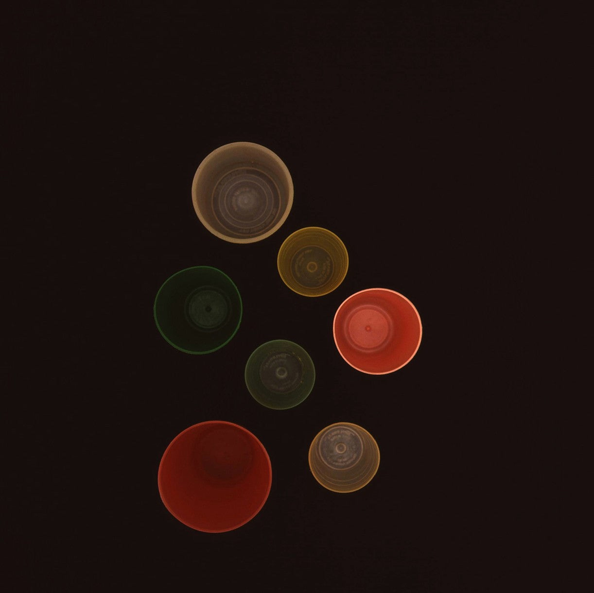 A black background with a bunch of different colored circles.