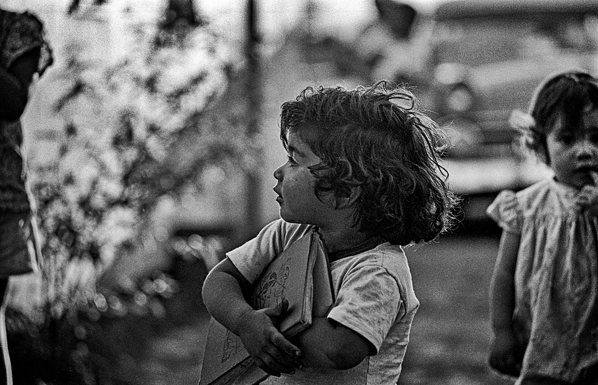 A little girl holding a book in her hands.