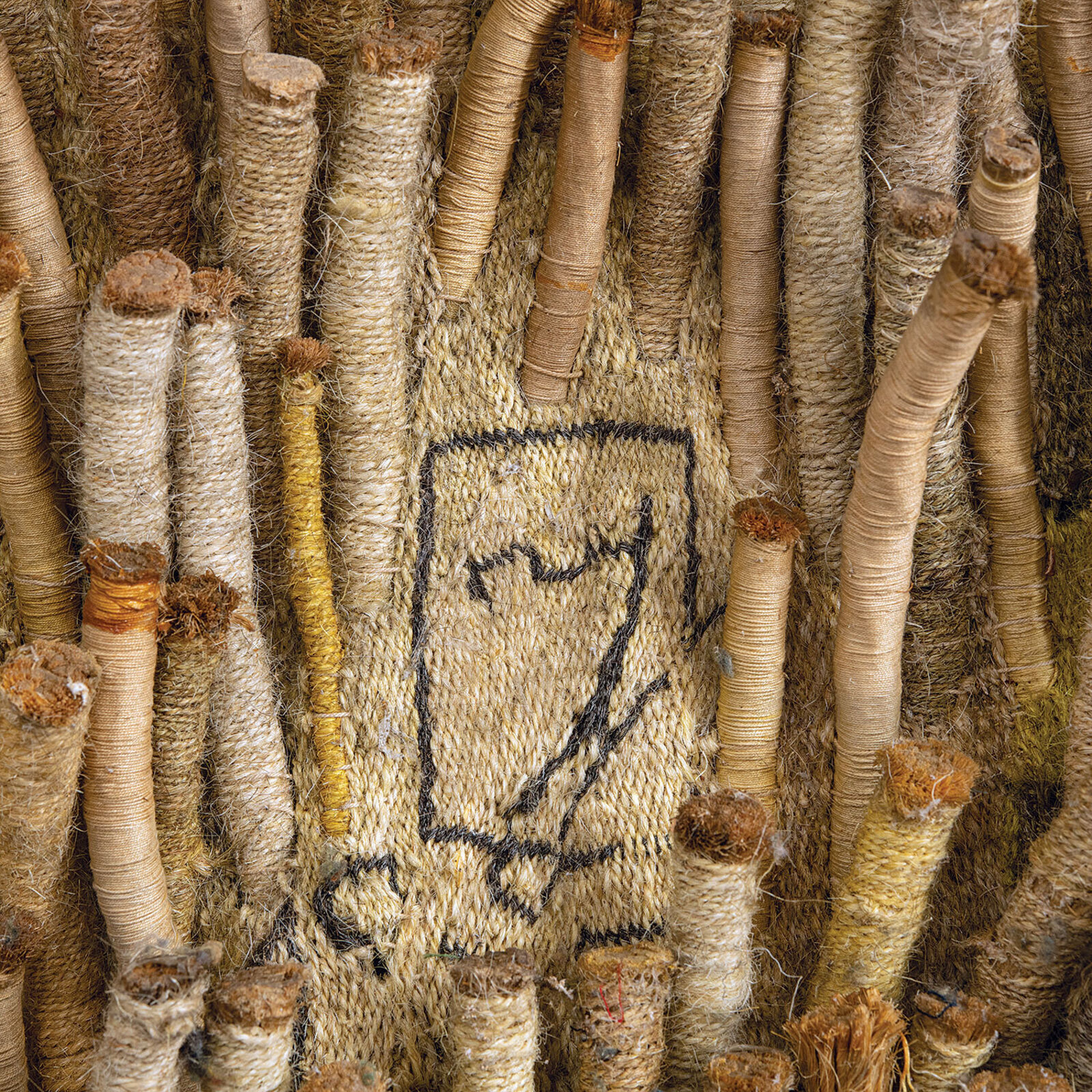 A large piece of art hanging on a wall in a room.