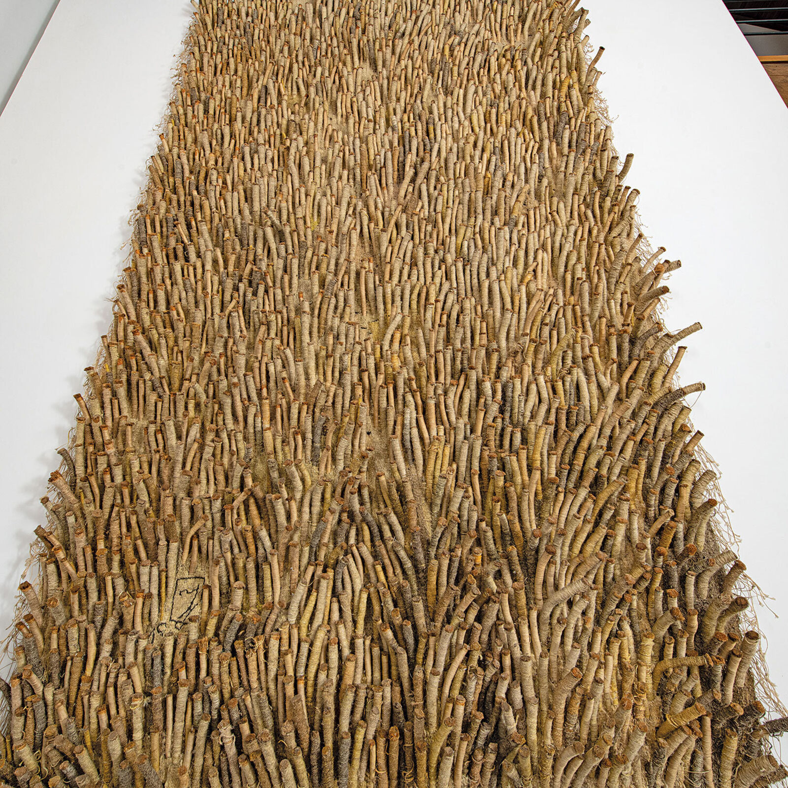 A large piece of art hanging on a wall in a room.