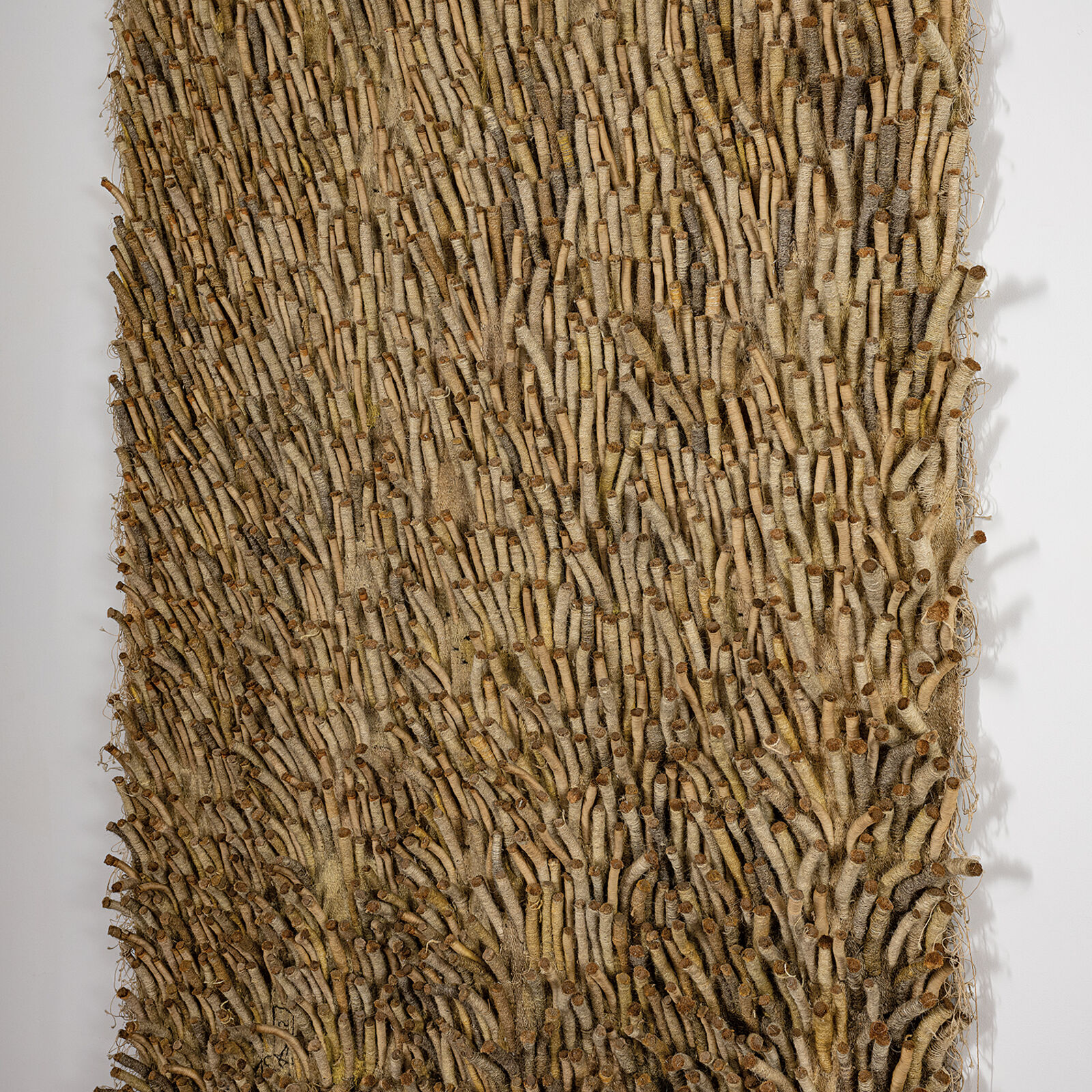 A large piece of art hanging on a wall in a room.