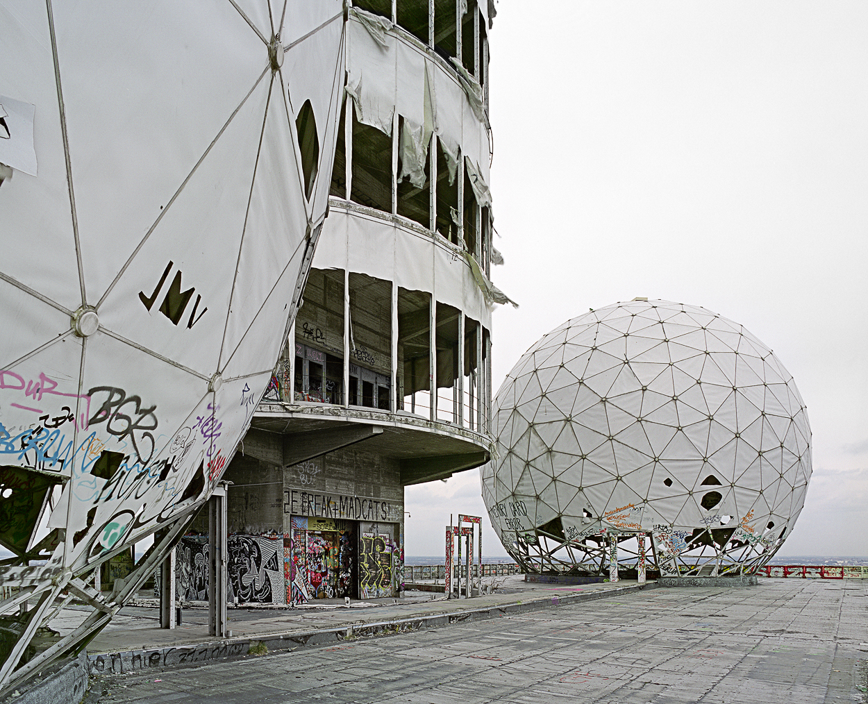 A large white building with graffiti on the side of it.