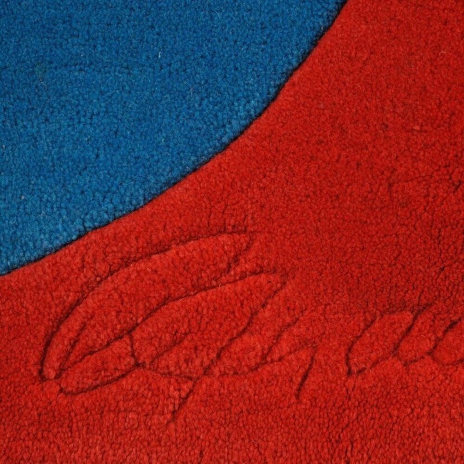 A bold graphic textile featuring large, overlapping letters in primary colors.