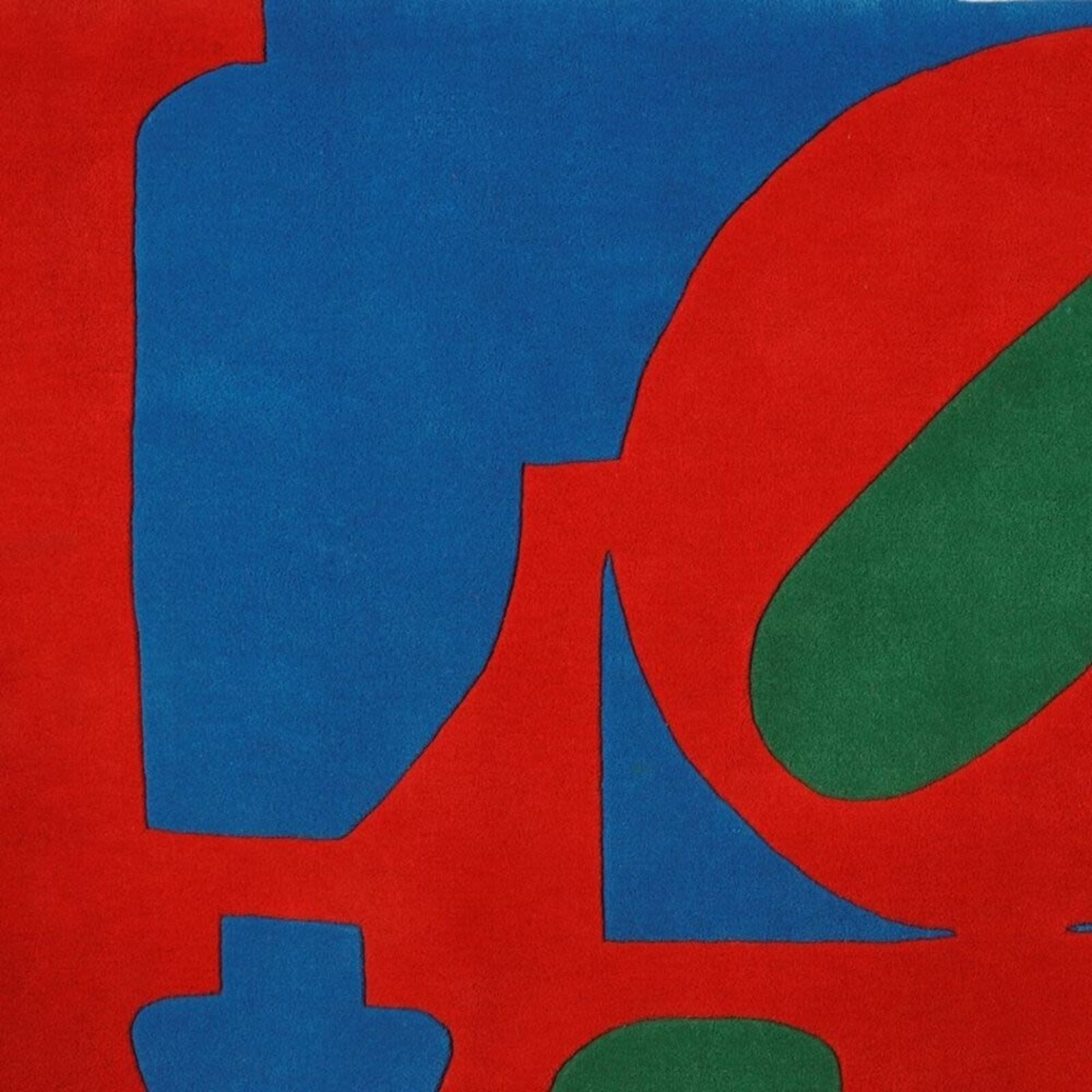 A bold graphic textile featuring large, overlapping letters in primary colors.