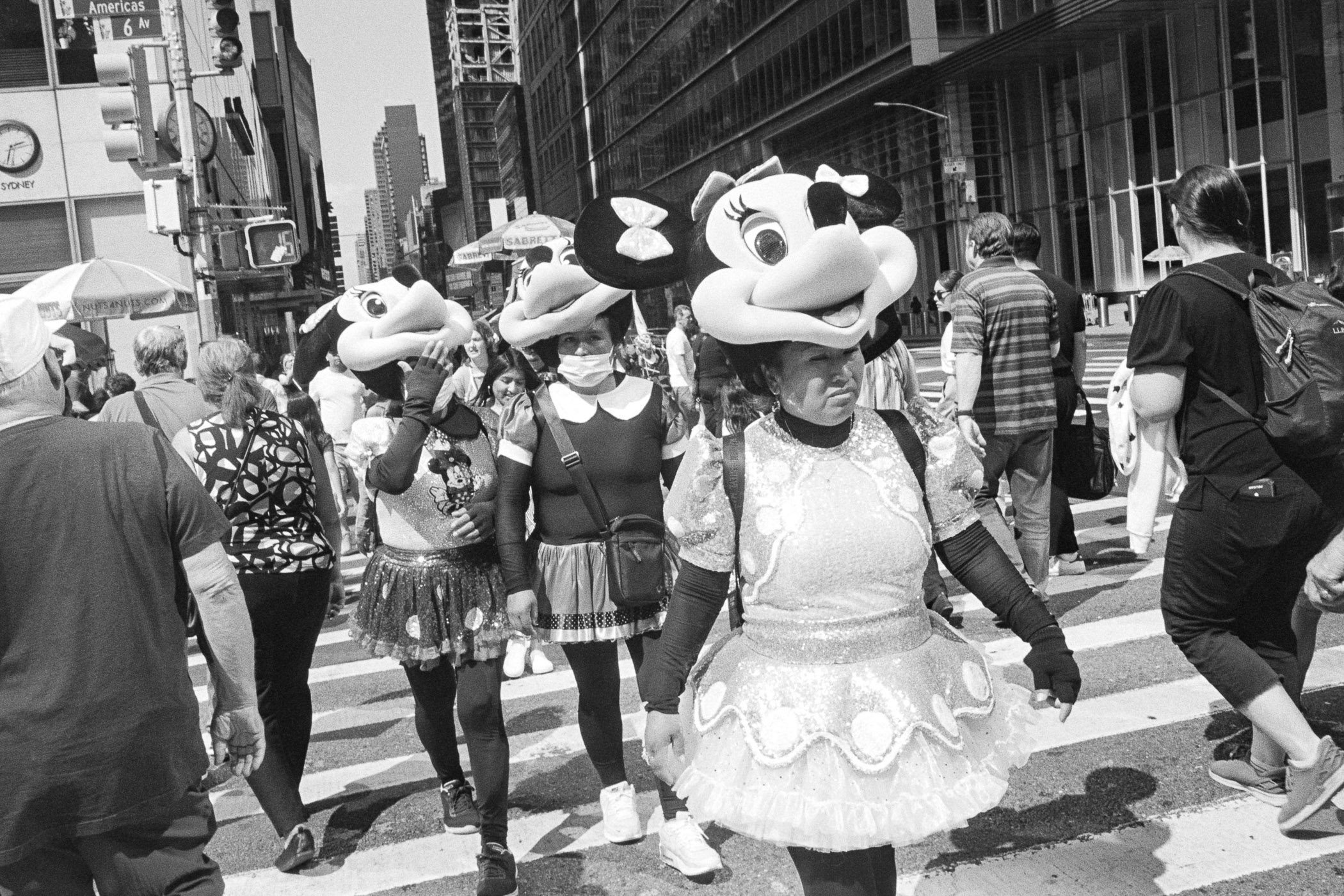 A group of people walking down a city street.