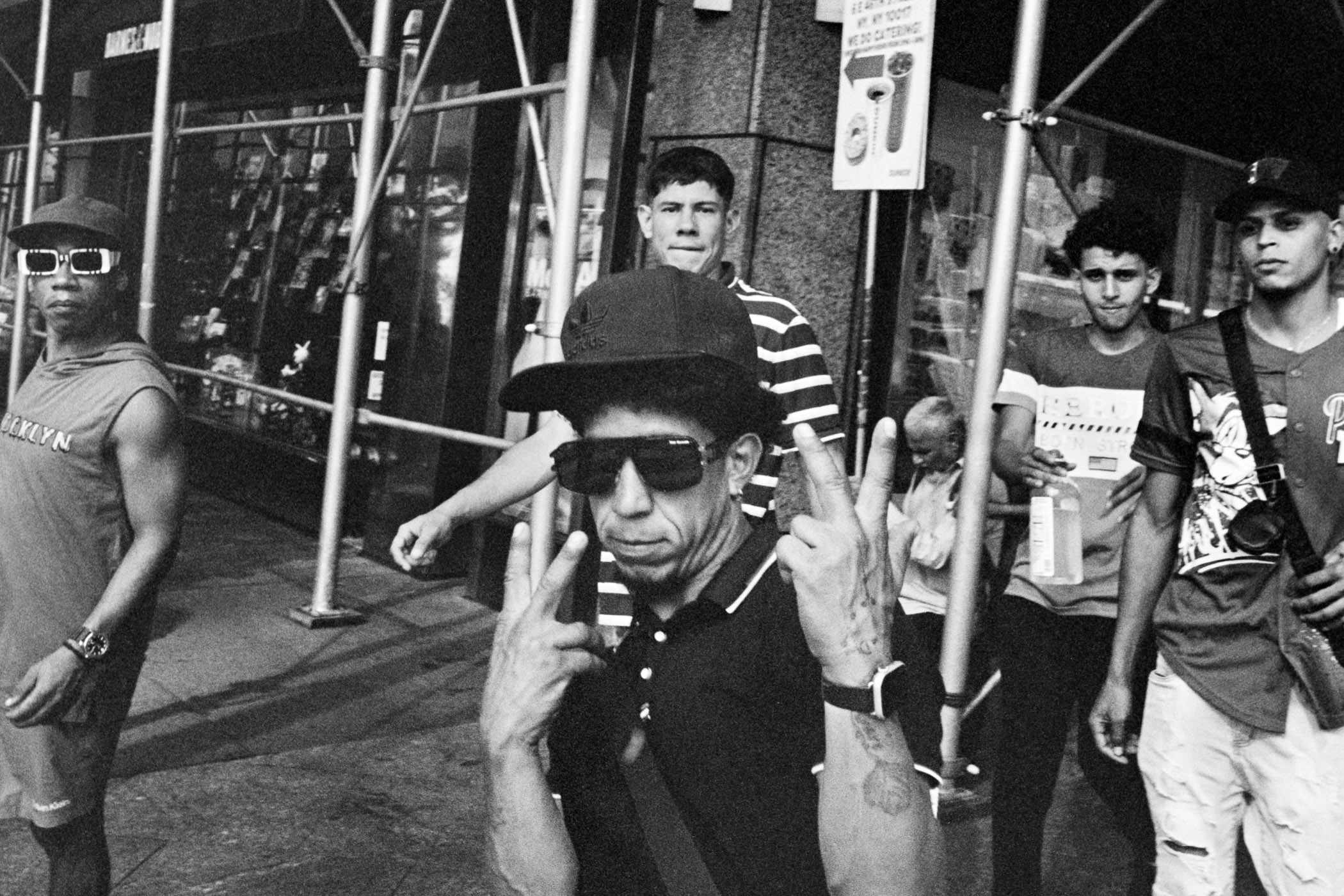 A group of men standing next to each other on a sidewalk.
