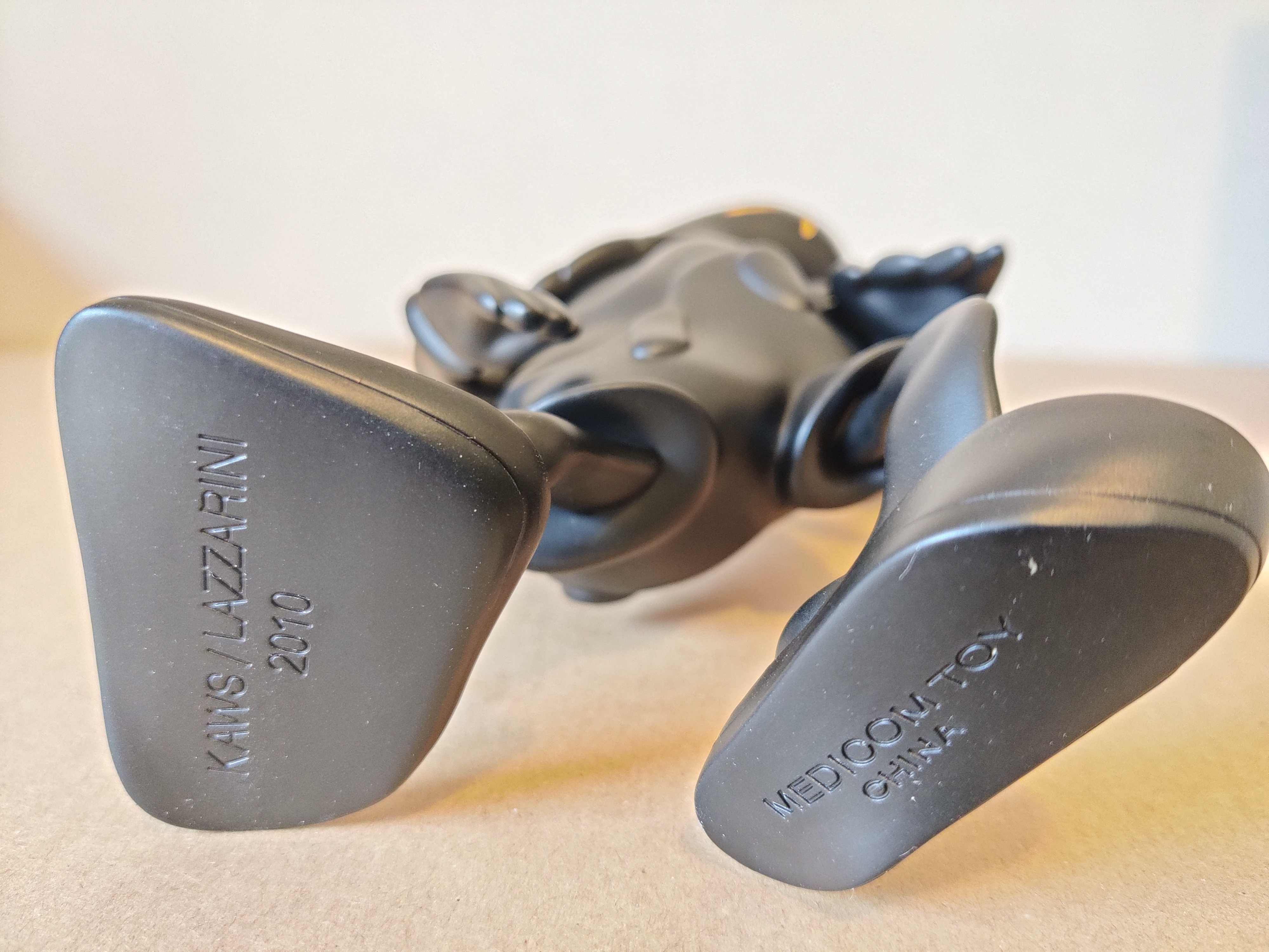 A black figurine of a man with a hat on his head.