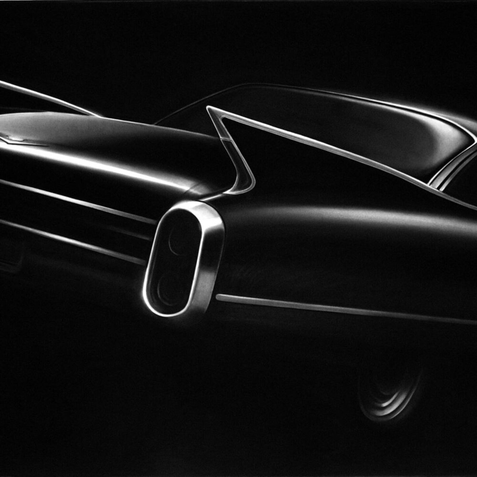A black and white photo of a classic car on a wall.