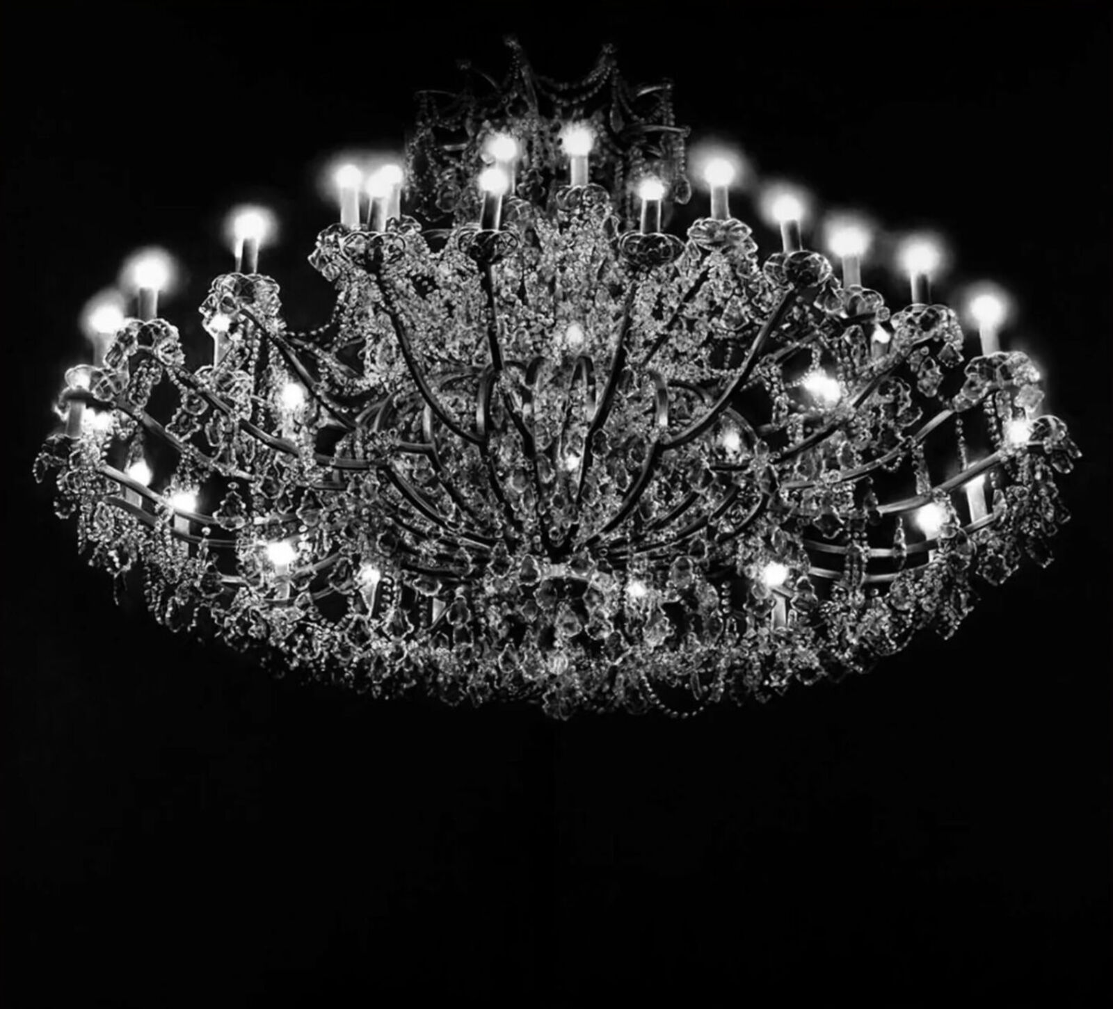A large chandelier with many lights hanging from the ceiling.