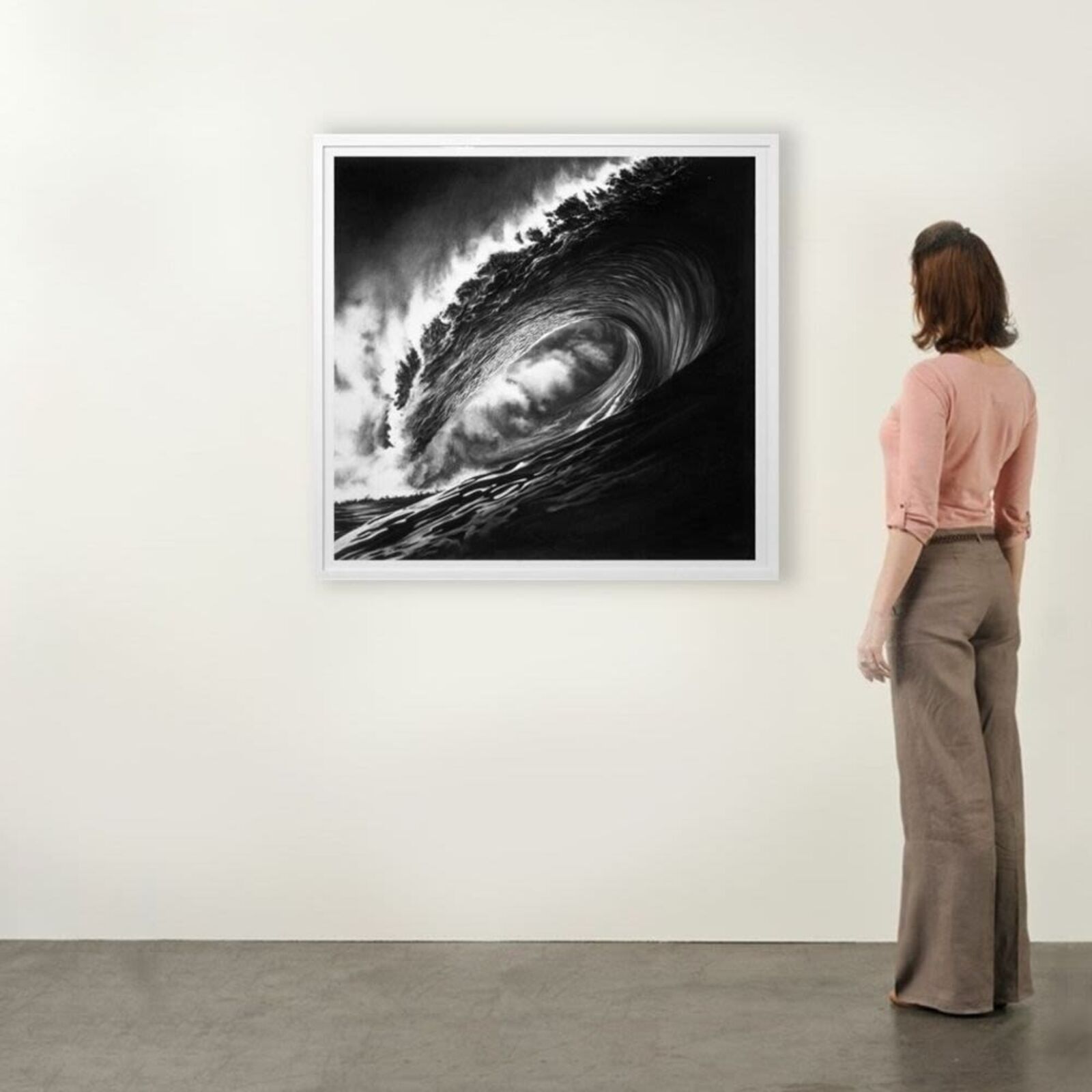 A black and white photo of a large wave in the ocean.
