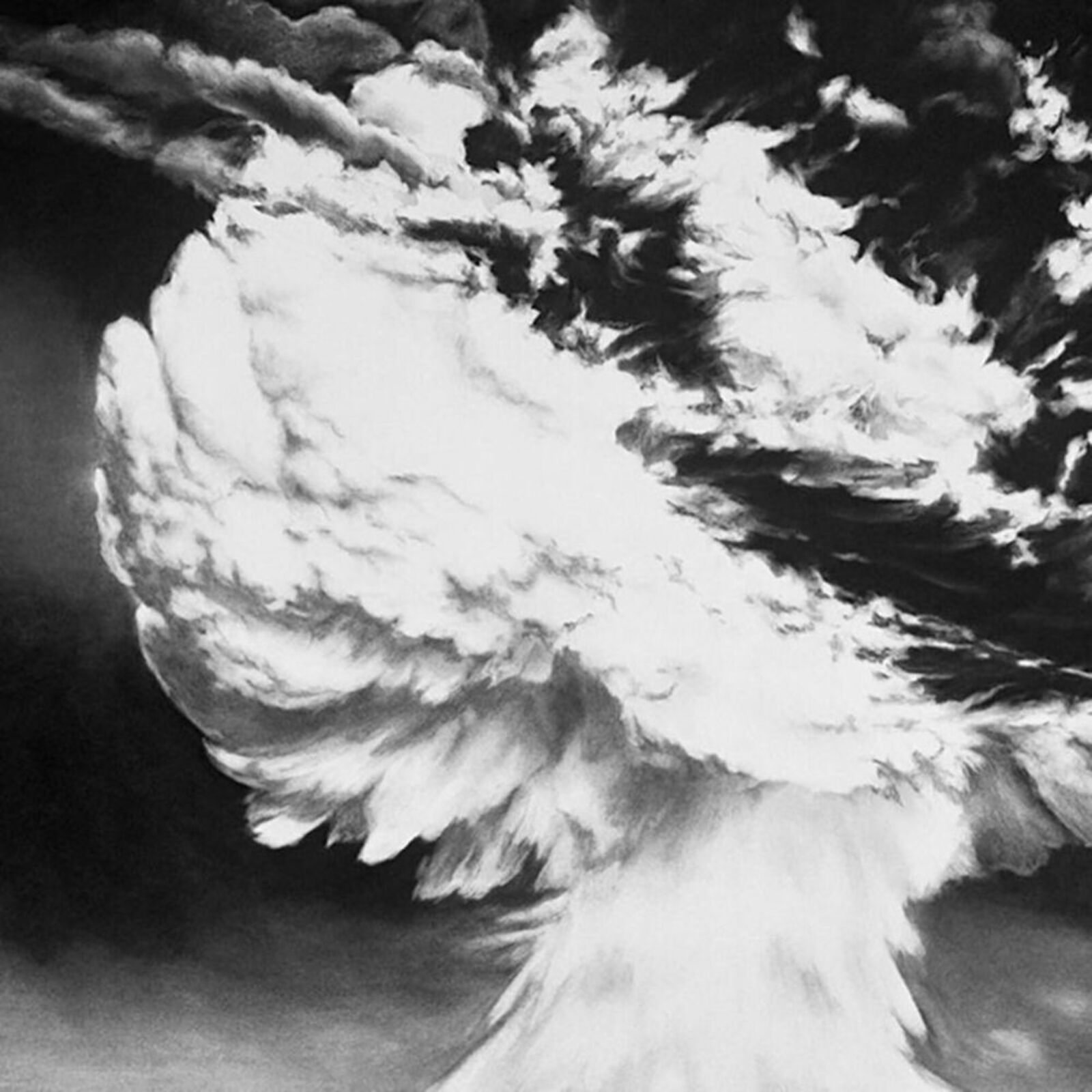 A black and white photo of a mushroom cloud over the ocean.