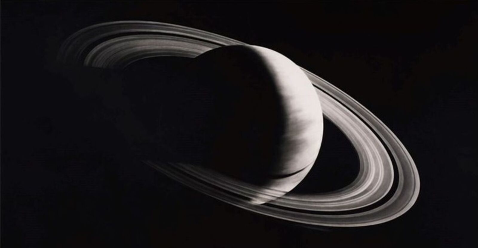 A black and white photo of a saturn in a white frame.