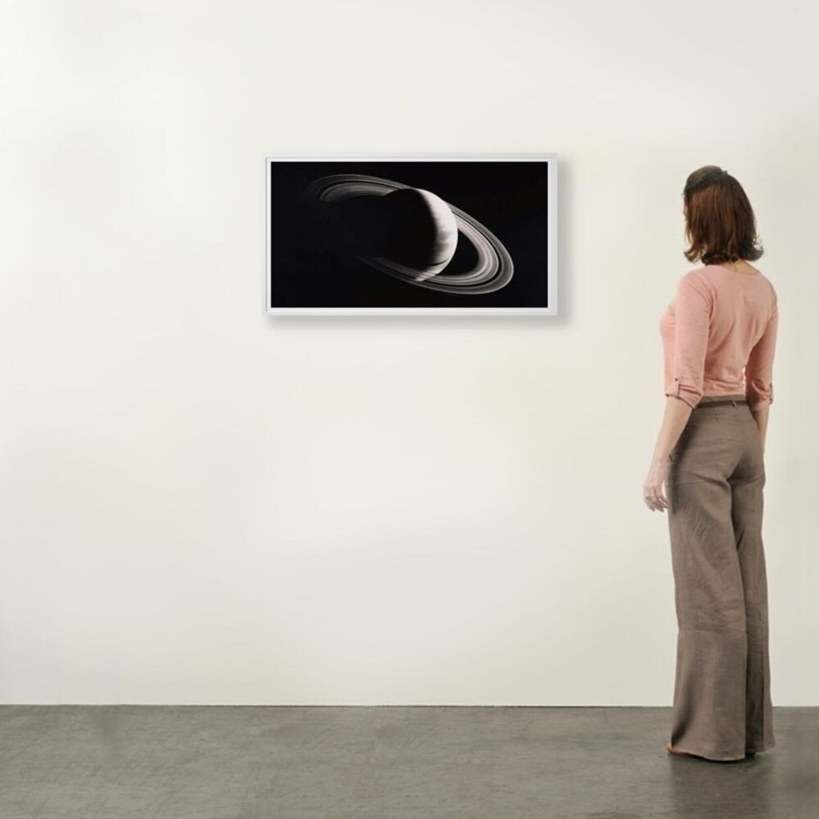 A black and white photo of a saturn in a white frame.